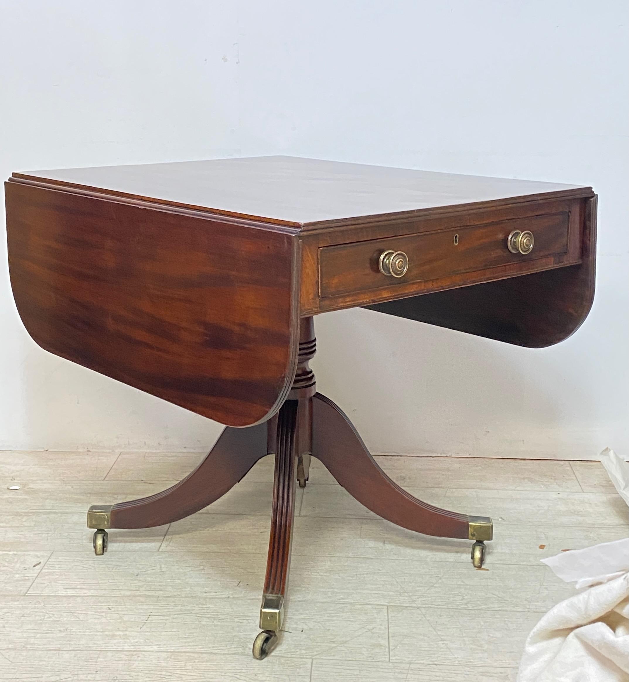 Early 19th century English George III period mahogany Pembroke style drop leaf side table or breakfast table. Having a single drawer and a false drawer on the back end. In excellent original condition accept for the top that looks to have been