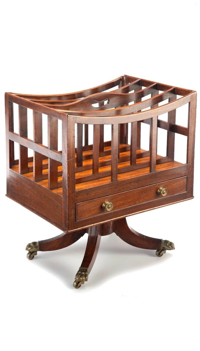 An exceptional, good quality, Regency period mahogany canterbury from the early 19th century. Born in England, the rolling sheet music stand features a partitioned open top slatted upper divided into four sections, over the incorporated single