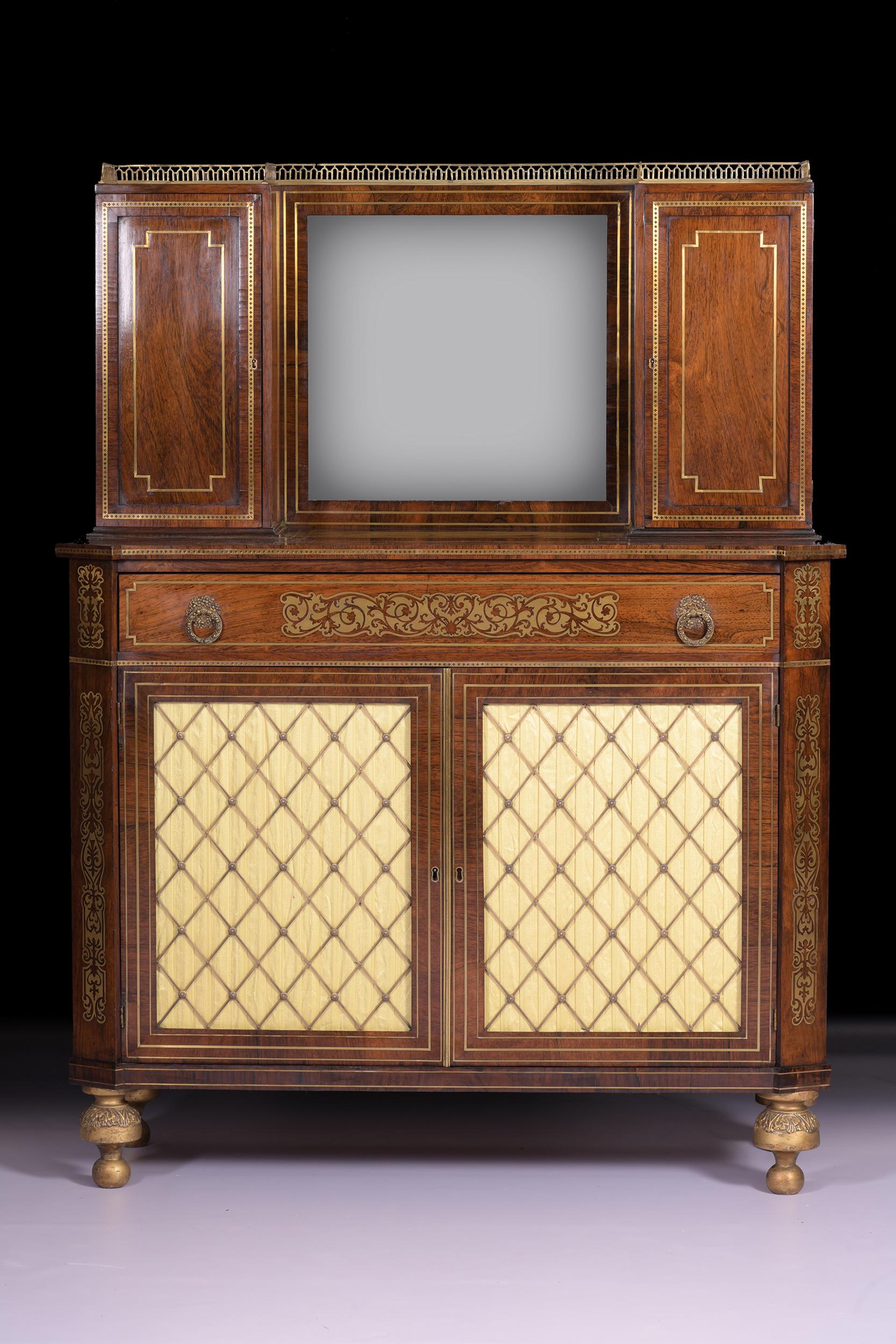 A ver fine Regency Goncalo Alves and brass inlaid side cabinet in the manner of John Mclean, of rectangular form, with raised back centred with a mirror plate, flanked by twin cupboard compartments, the base with angels corners and long frieze