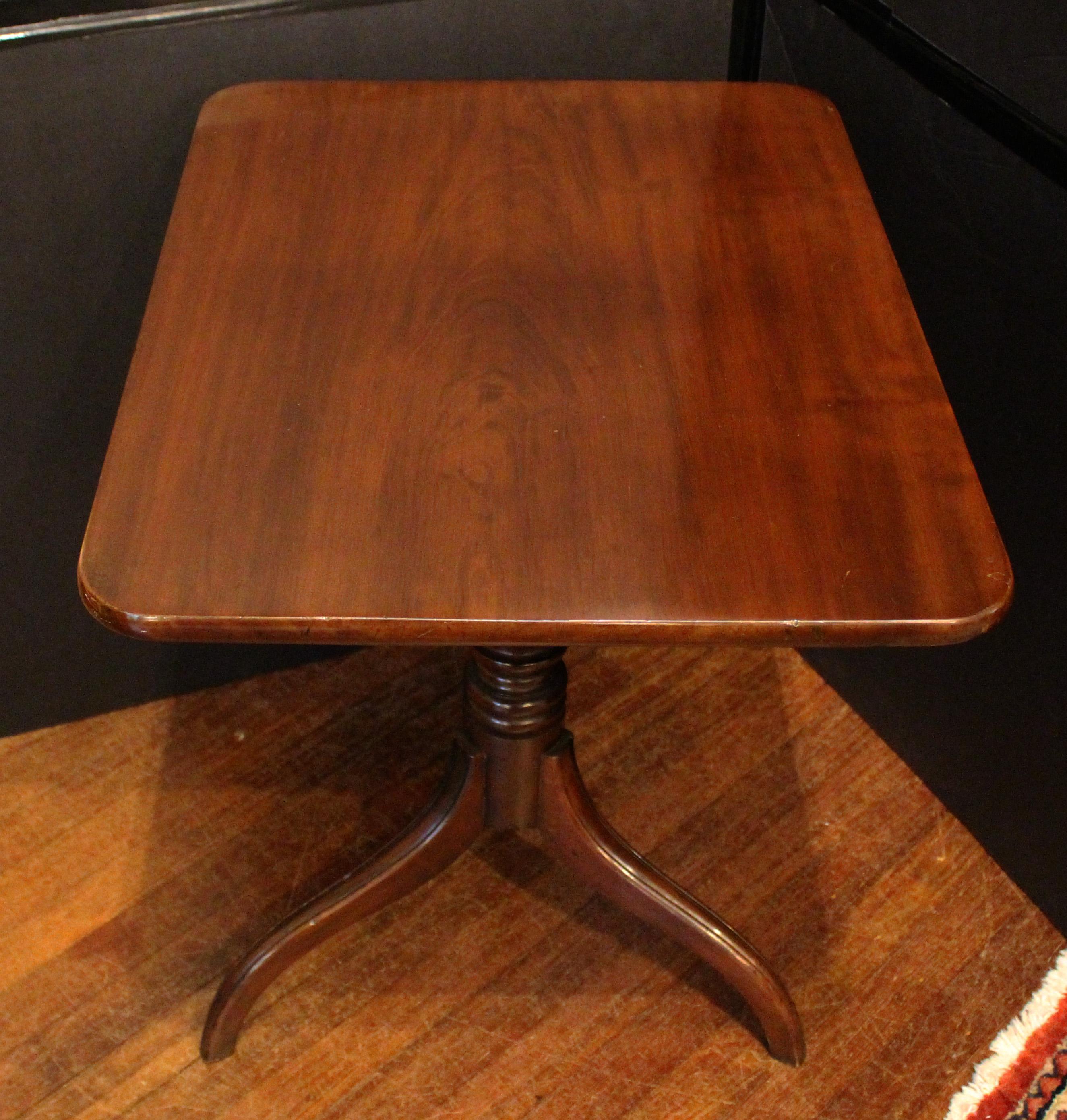 Early 19th century tilt-top side table, English. George IV to William IV period. Rectangular top with rounded corners, raised on molded tripod base with very well turned standard. Fine quality mahogany. 27 7/8