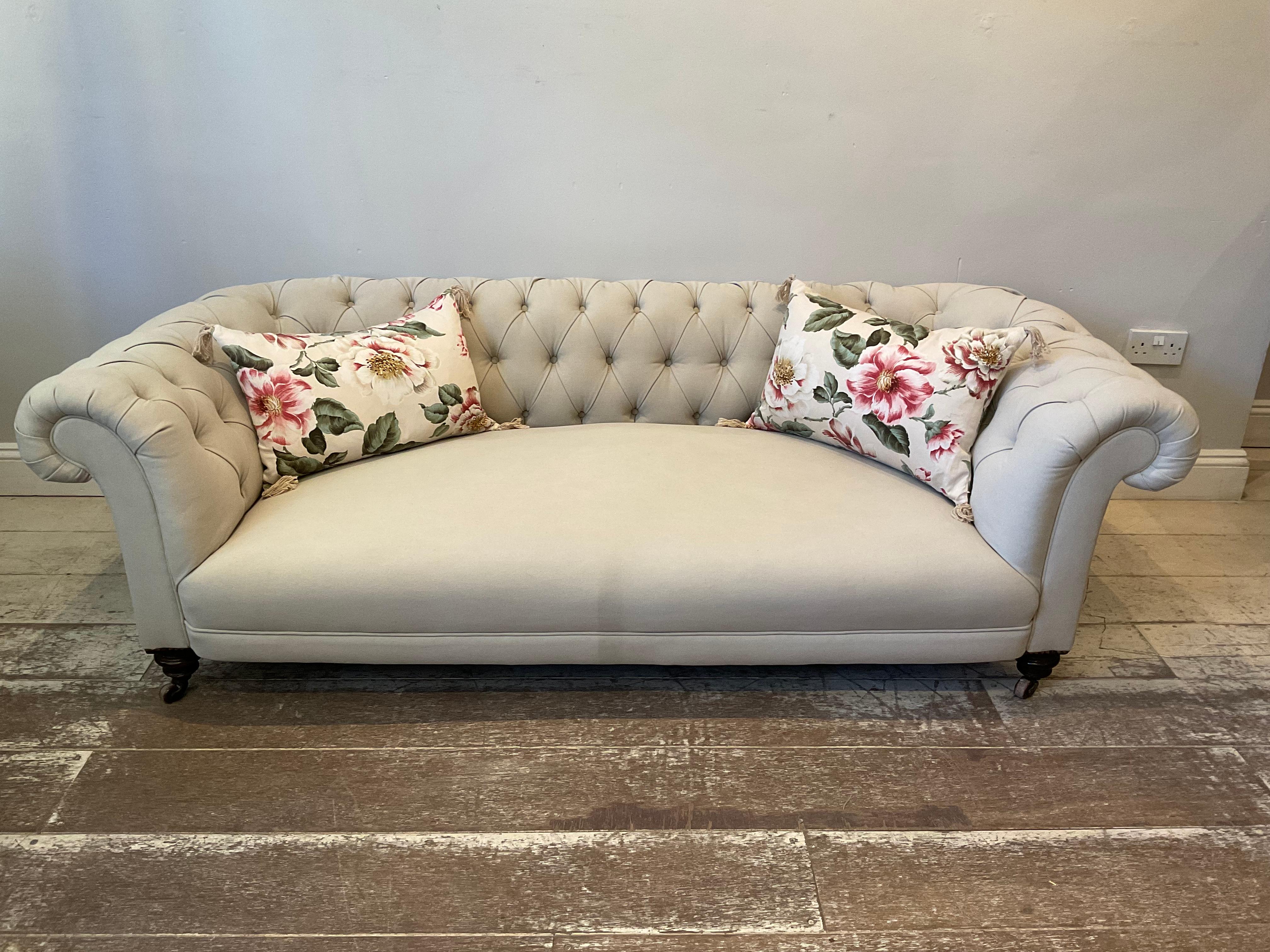 19th century English Chesterfield sofa.
Good size three-seater button back sofa.
A very comfortable sofa which has been recently reupholstered in a plain neutral fabric. The sofa is buttoned across the back and also on its scrolled arms and sits
