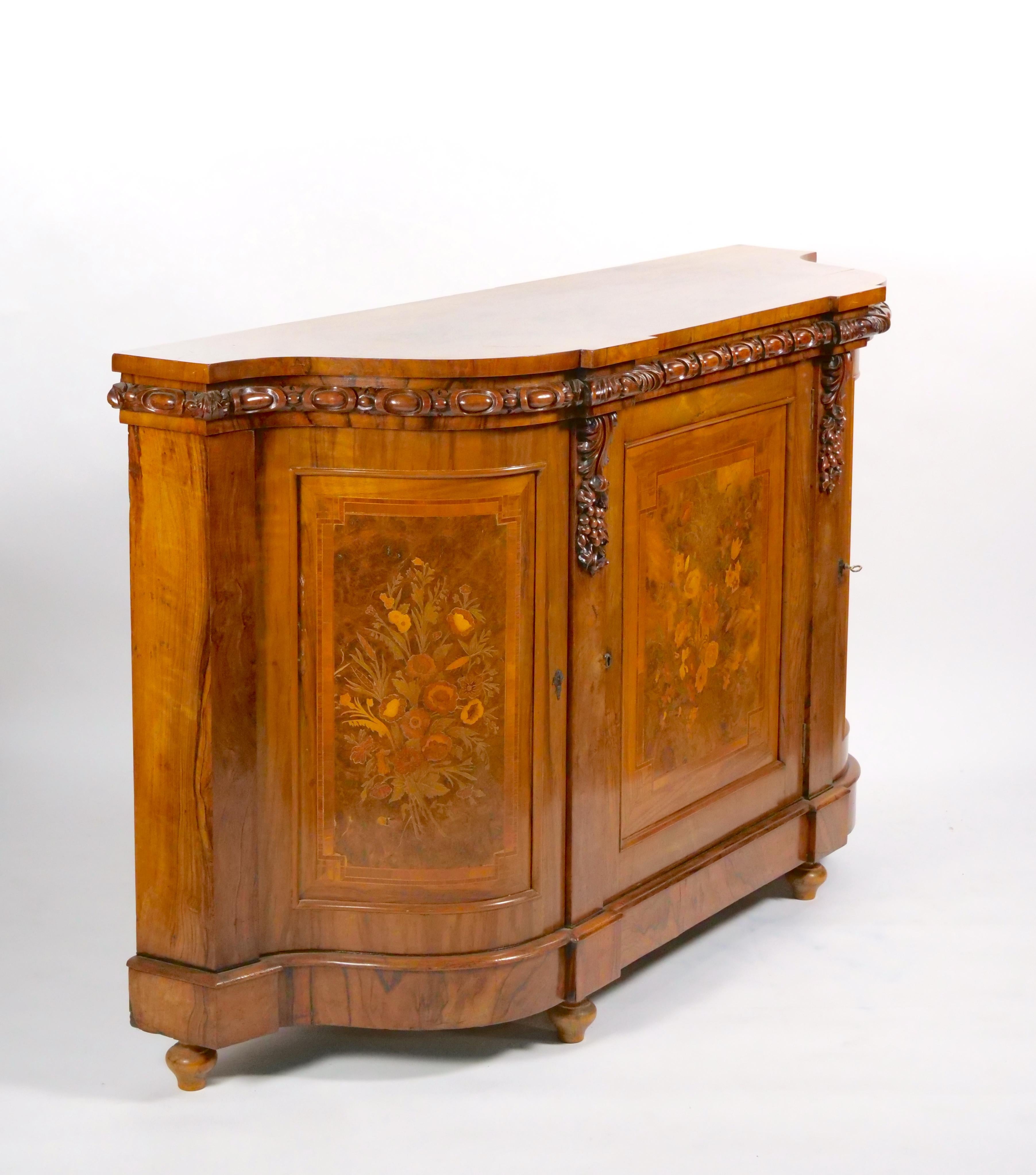 Elevate your living space with this exquisite Early 19th Century Victorian Figured Walnut and Marquetry Decorated Demilune Shape Credenza. This piece is a true representation of the Victorian era's elegance, craftsmanship, and attention to detail.