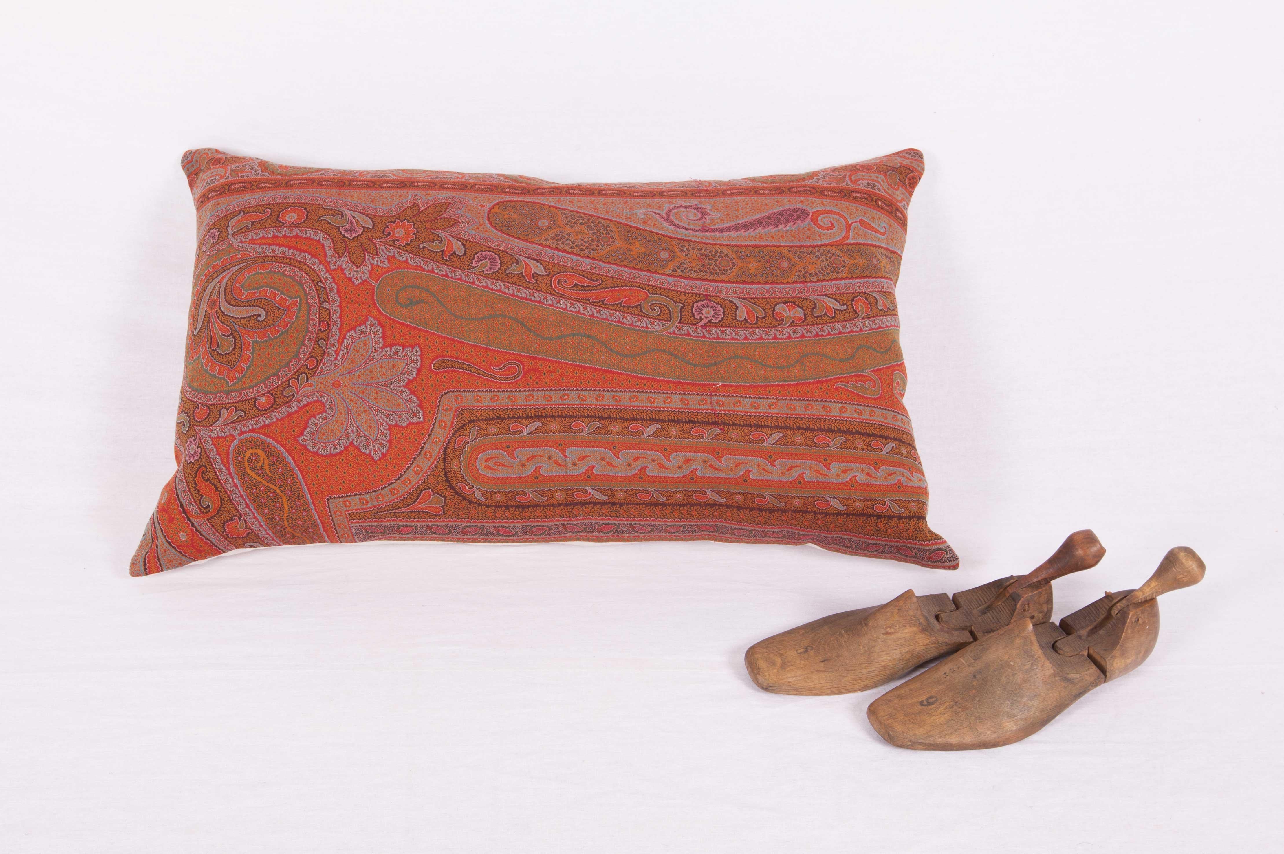 The pillow is made out of an early 19th century paisley shawl. It does not come with an insert but it comes with a bag made to the size and out of cotton to accommodate the filling. The backing is made of linen. Please Note: Filling is not provided.