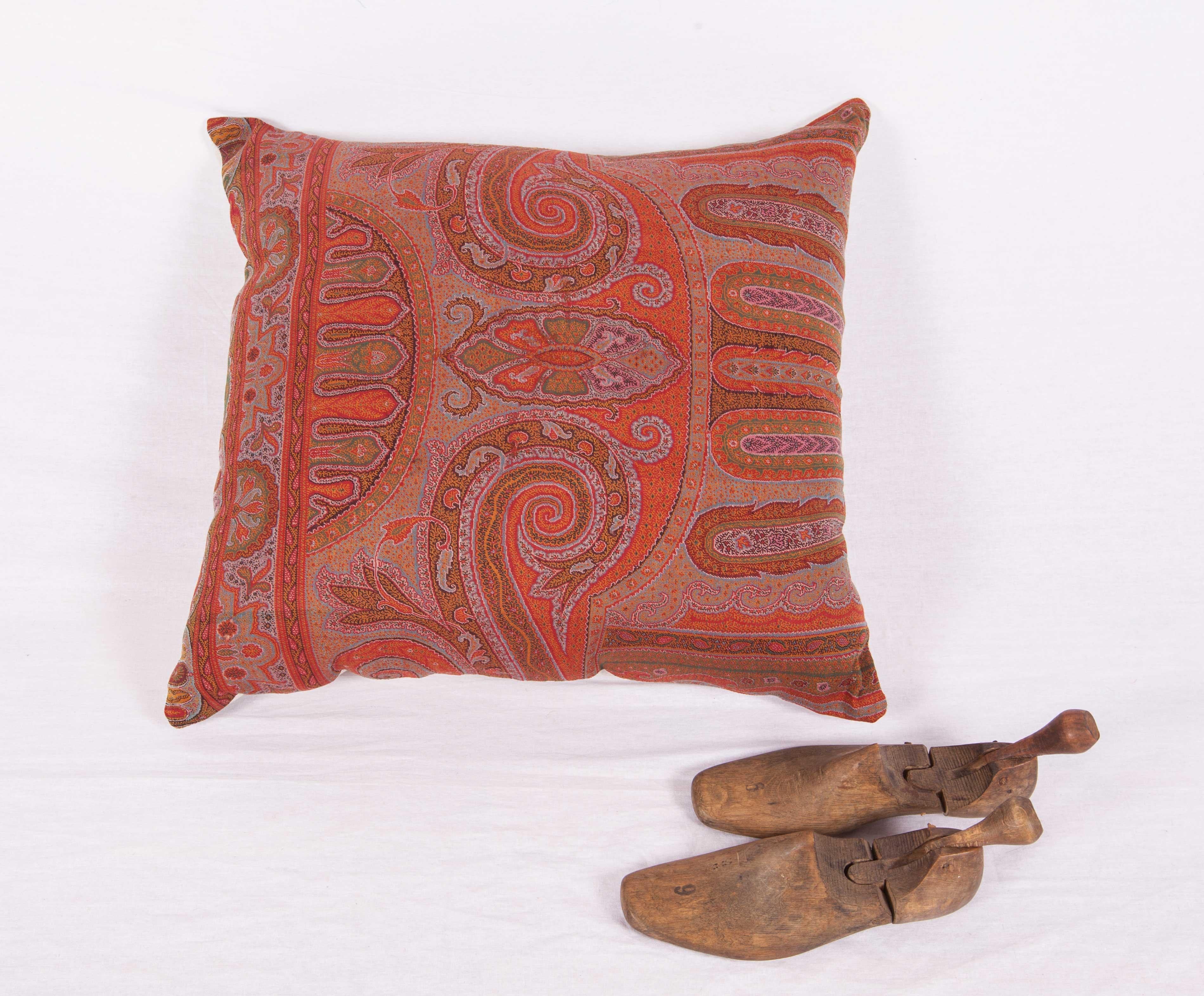 The pillow is made out of a early 19th century paisley shawl. It does not come with an insert but it comes with a bag made to the size and out of cotton to accommodate the filling. The backing is made of linen. Please Note: Filling is not provided.