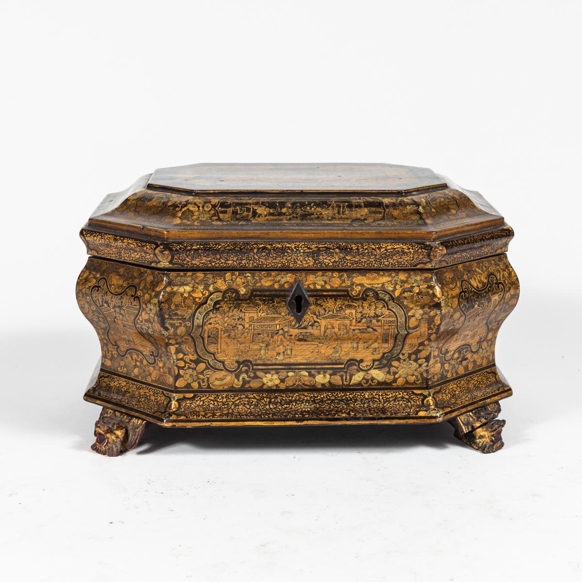1820s lacquered chinoiserie box on elegant carved feet. Produced at the height of England's craze for Chinese lacquerware, this item features an extremely intricate gold-toned pattern on its surface. An excellent example of the craftsmanship of this