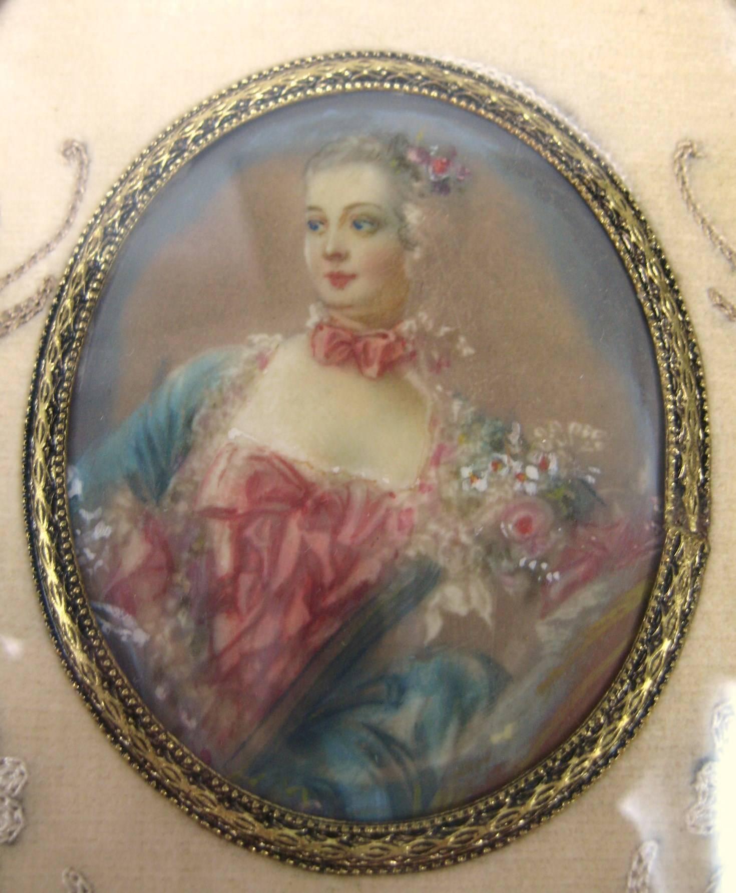 Hand painted early 19th century miniature under glass. Finely painted details on this lovely lady. In a brass oval frame, with floral embroidery surround.
Painting measures 2.5 in x 2 in
Frame measures 6.25 in x 3.75 in.