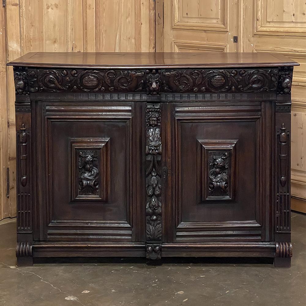 Early 19th century Flemish Renaissance buffet is a lively piece, commissioned by a wealthy patron who wanted a bit of whimsy in its character! Abundant symbolism abounds in the carved embellishment of the piece, sculpted in glorious full relief for