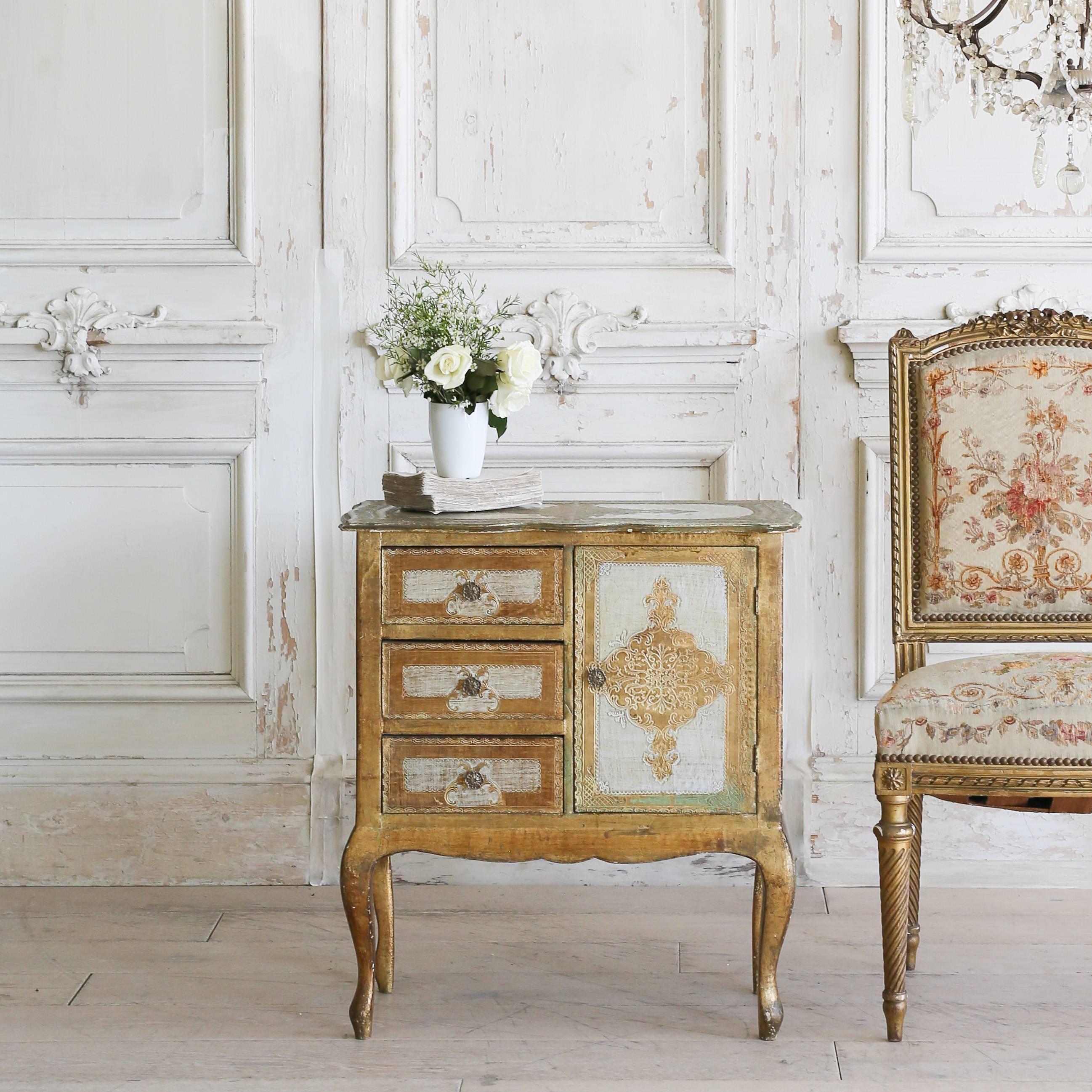 Charming nightstand with three drawers and a single cupboard. Gorgeous roomy piece in Classic Italian gilt and cream designs atop Louis XV style legs. A lovely piece for a bedroom or as storage in a bath suite.
