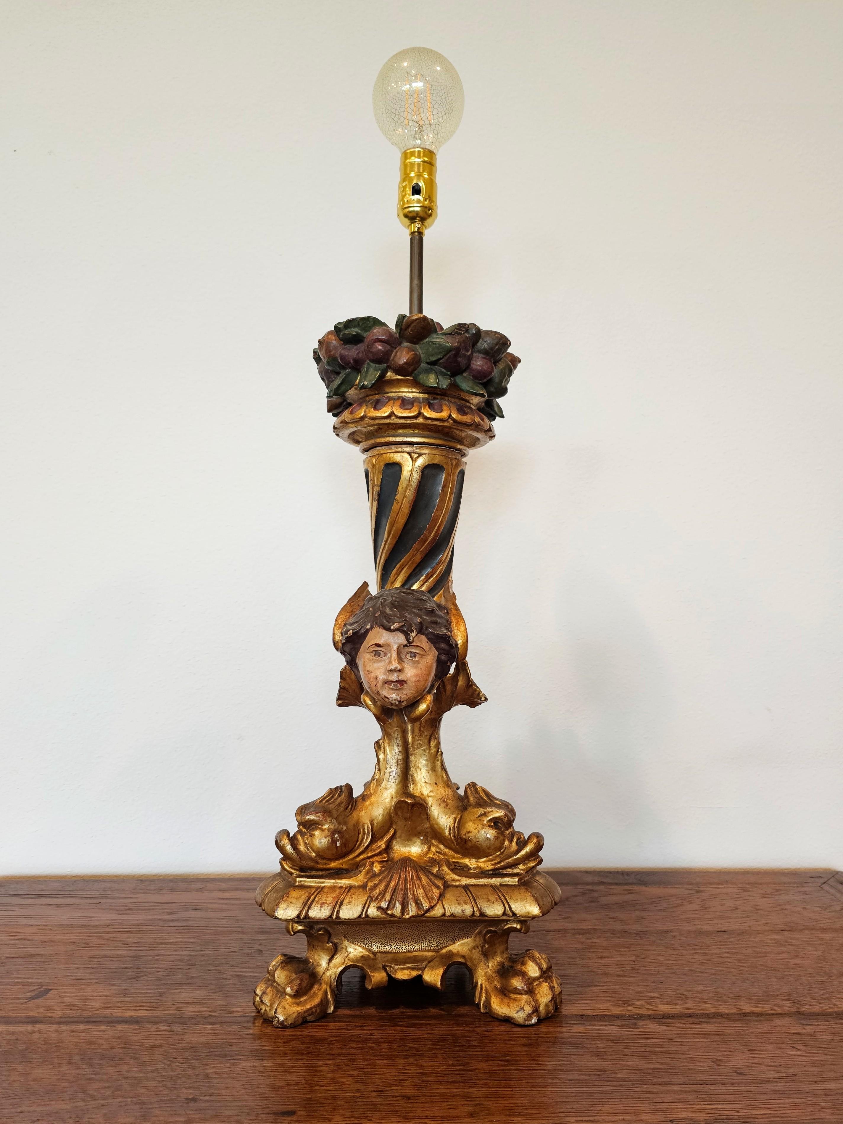 A fabulous French Empire period giltwood figural candlestick, early 19th century, now professionally electrified and fashioned as a single-light table lamp.

Exquisitely hand carved, sculpted, gessoed and polychromed gilded wood, exceptionally