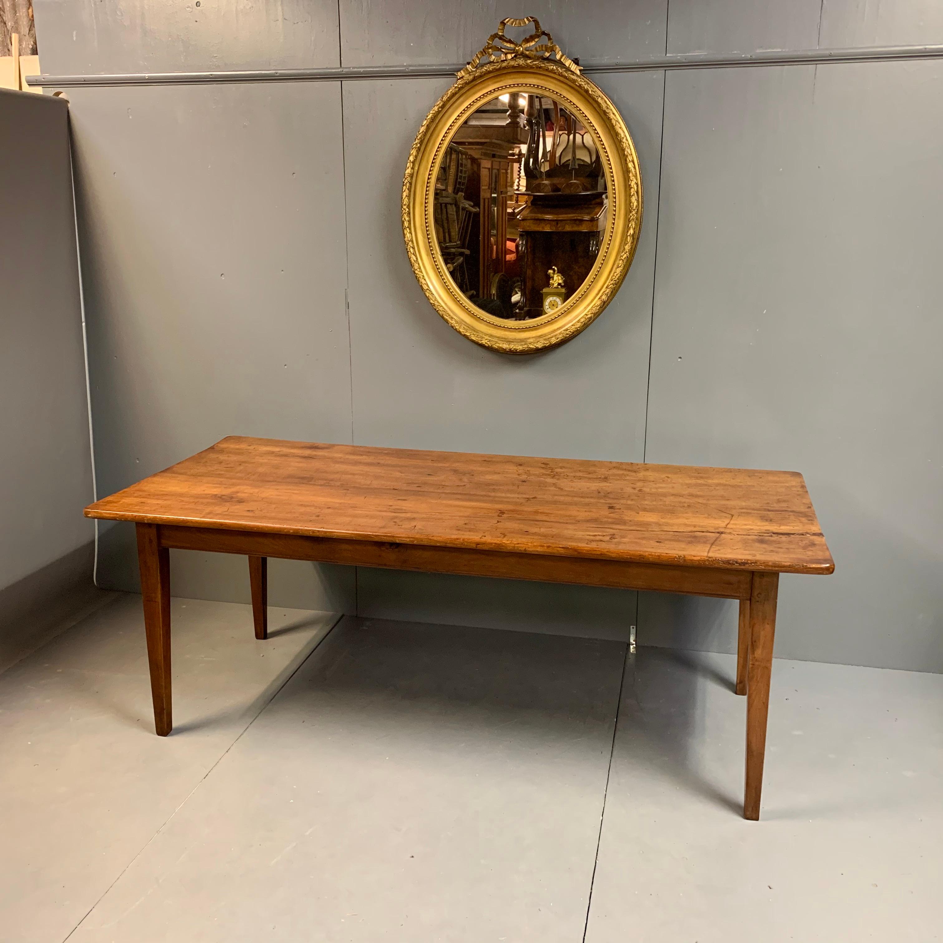 This is a beautiful early 19th century French cherrywood farmhouse table with the wide top made from just two planks.
The table is a comfortable 8-10-seat size and with the pullout / pull-out carving slide makes for a comfortable 10-seat size.