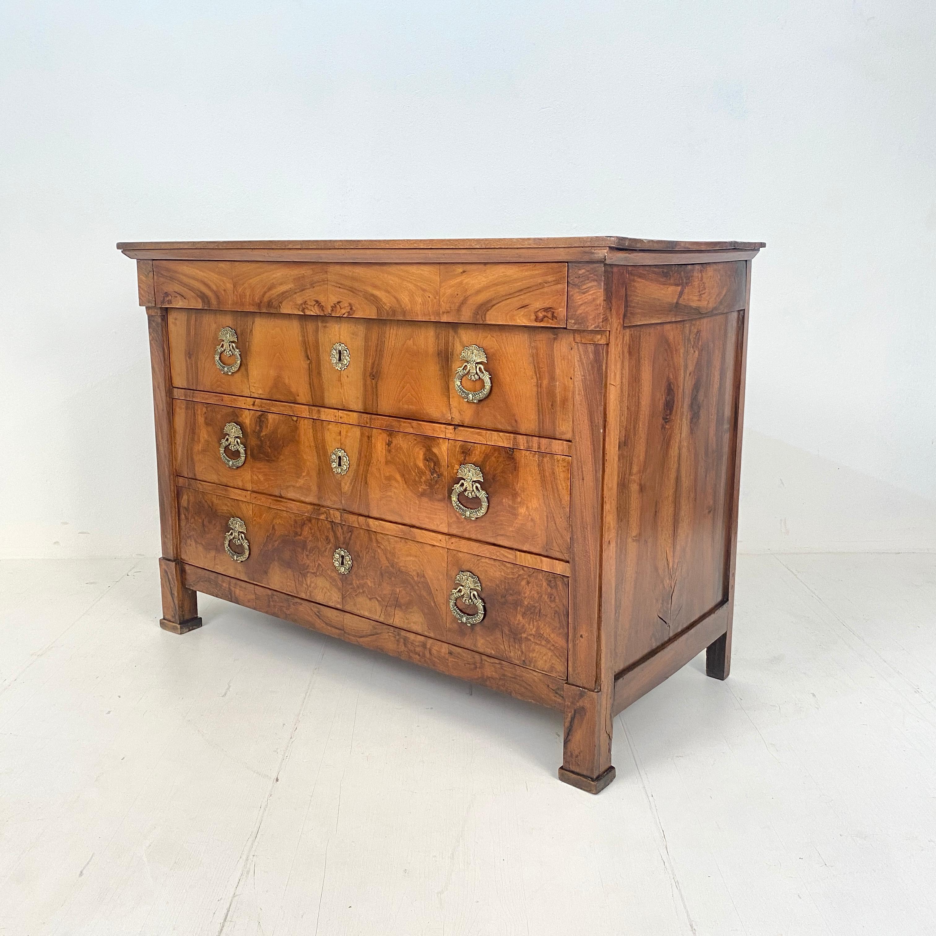 This Early 19th Century French Chest of Drawers was made around 1820. 
It is made out of solid brown walnut and pine. It remains it original brass hardware.
A unique piece which is a great eye-catcher for your antique, modern, space age or