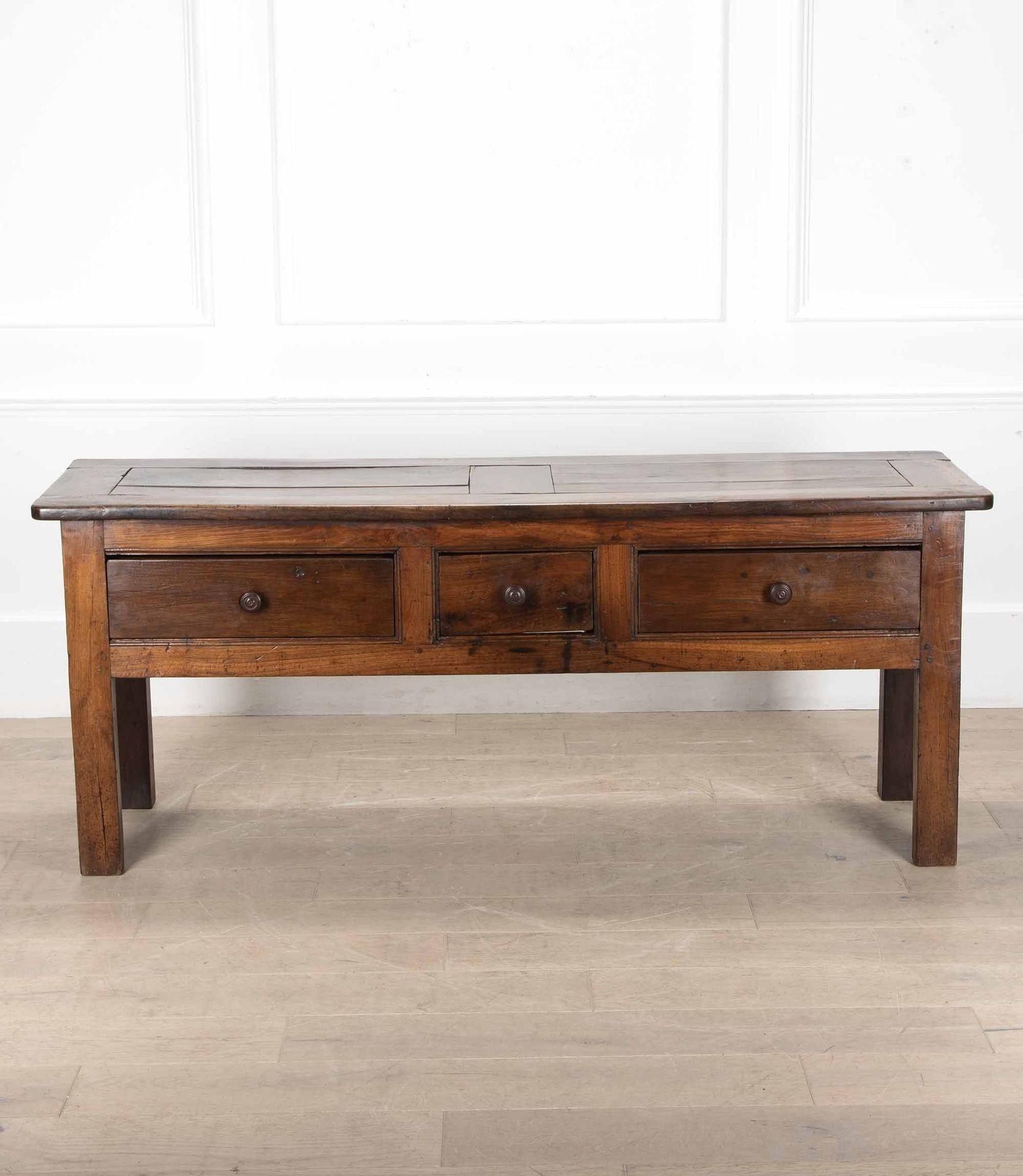 Lovely early 19th Century French chestnut dresser base or serving table.

With turned wooden knobs, three deep drawers and a panelled top. Polished on all sides so it can stand freely.

Circa 1830, from the Brittany region of France.   