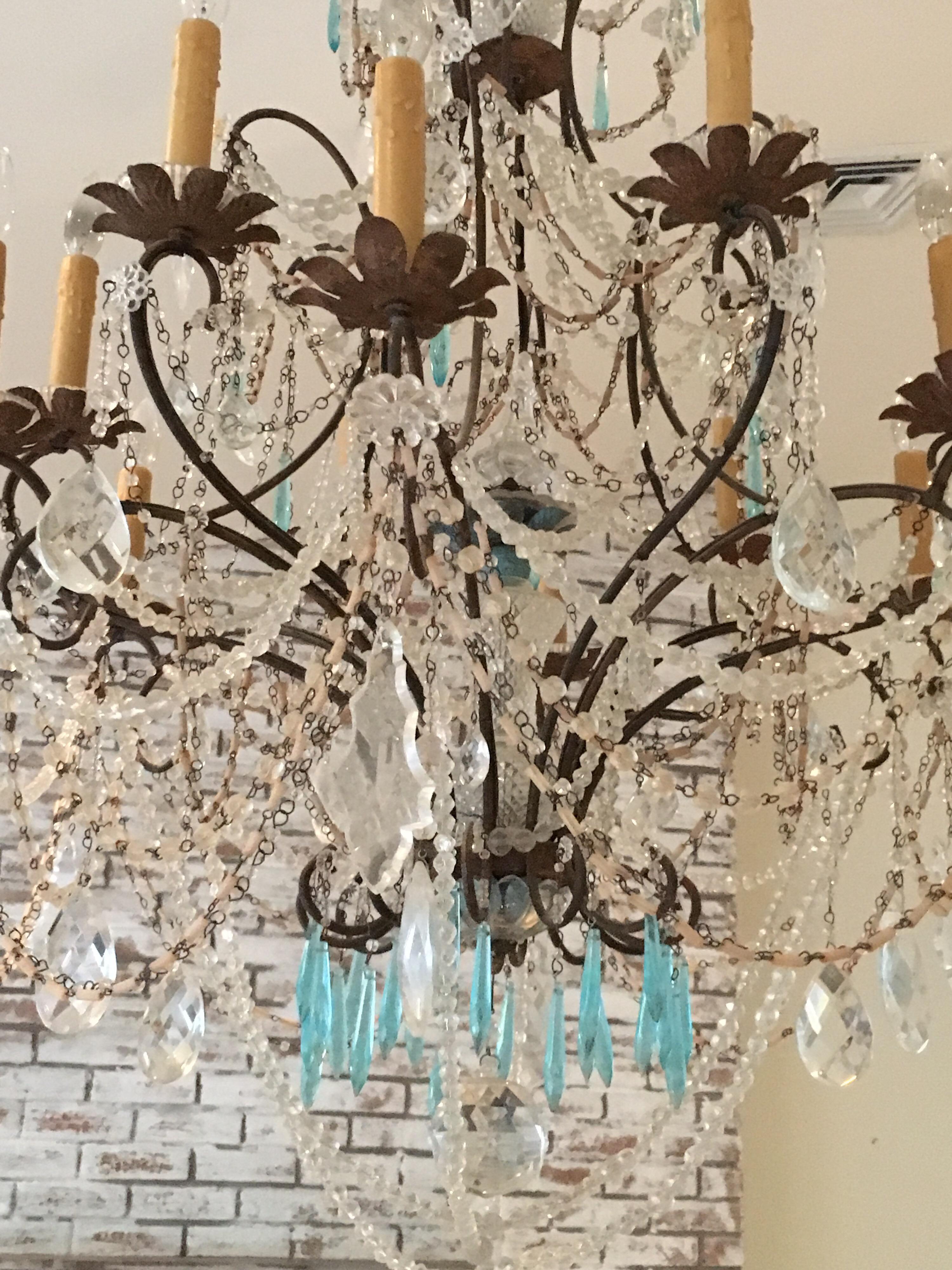Early 19th century French crystal chandelier. Draped with large size crystal bead roping, heavy pear shaped faceted drops, aqua faceted drops, large faceted round crystal. Iron structure with flower petal 12 arm candle lights. electrified.
45