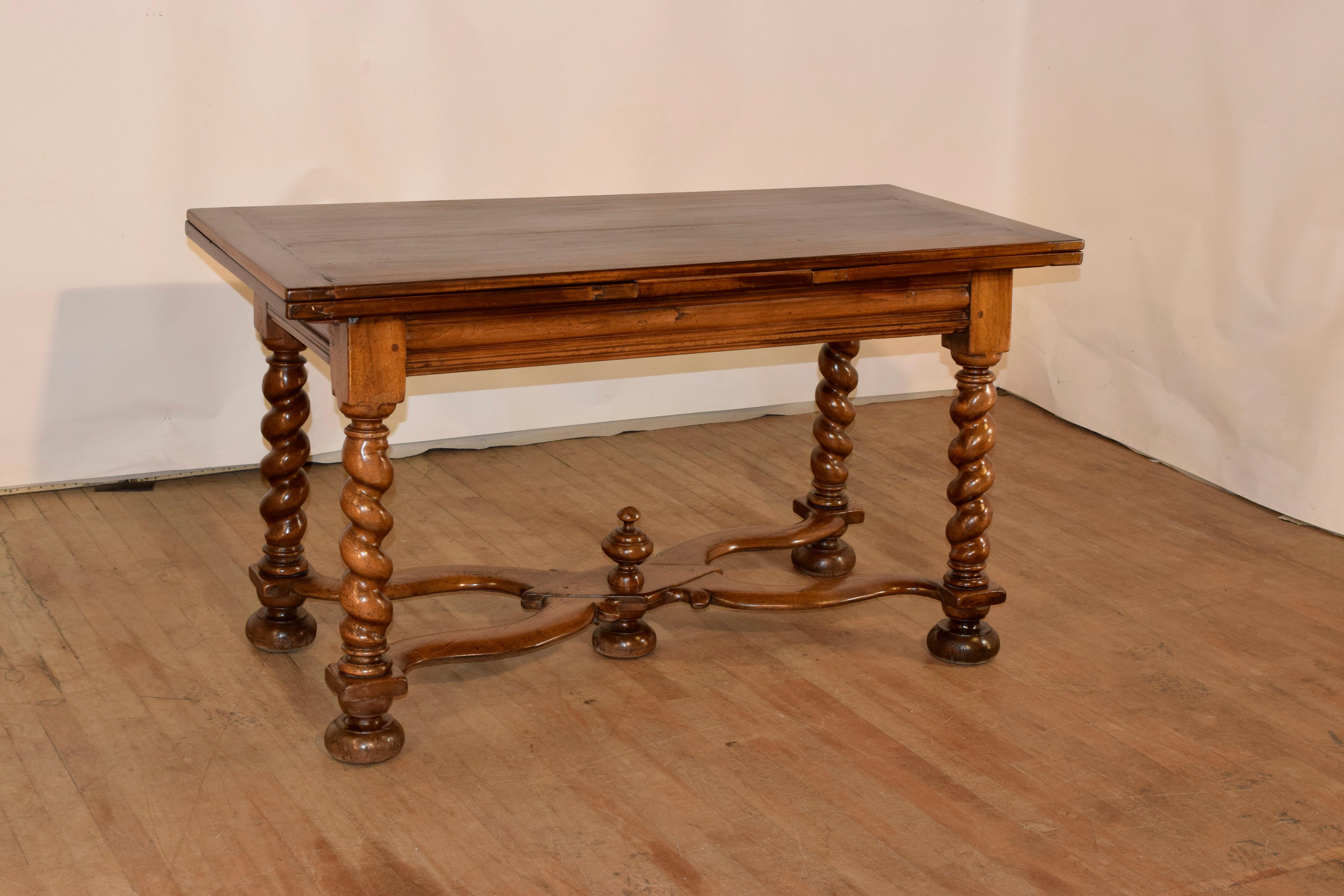 Early 19th century walnut draw leaf table from France. The top is banded on the ends to prevent shrinkage and has a wonderfully grained top. There are two leaves that extend for added length. The table open measures 100.63 inches in length. The top