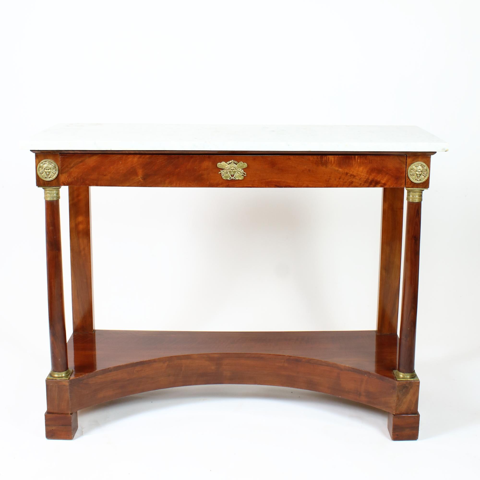 Early 19th century French Empire Large Neoclassical Walnut Console Table

An elegant Empire period console table with a with marble top above a frieze drawer, the frieze section is raised on columnar front legs and pilasters at the back, all