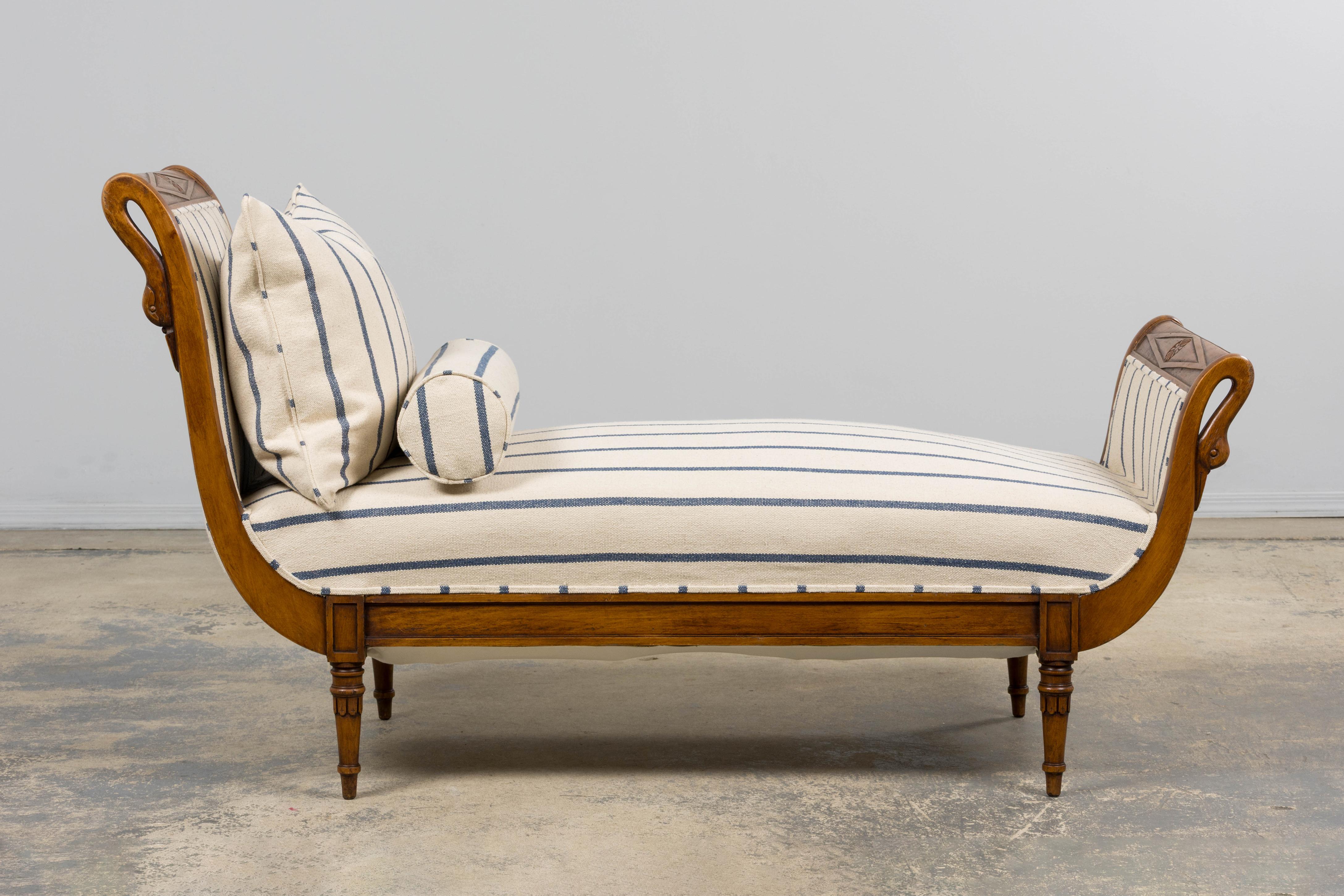 Eine exquisite französische Empire-Chaise Longue aus dem frühen 19. Jahrhundert, die in der Provence hergestellt wurde. Der aus Mahagoni handgefertigte Rahmen ist mit klassischen Motiven geschnitzt, seine geschwungenen Enden sind mit