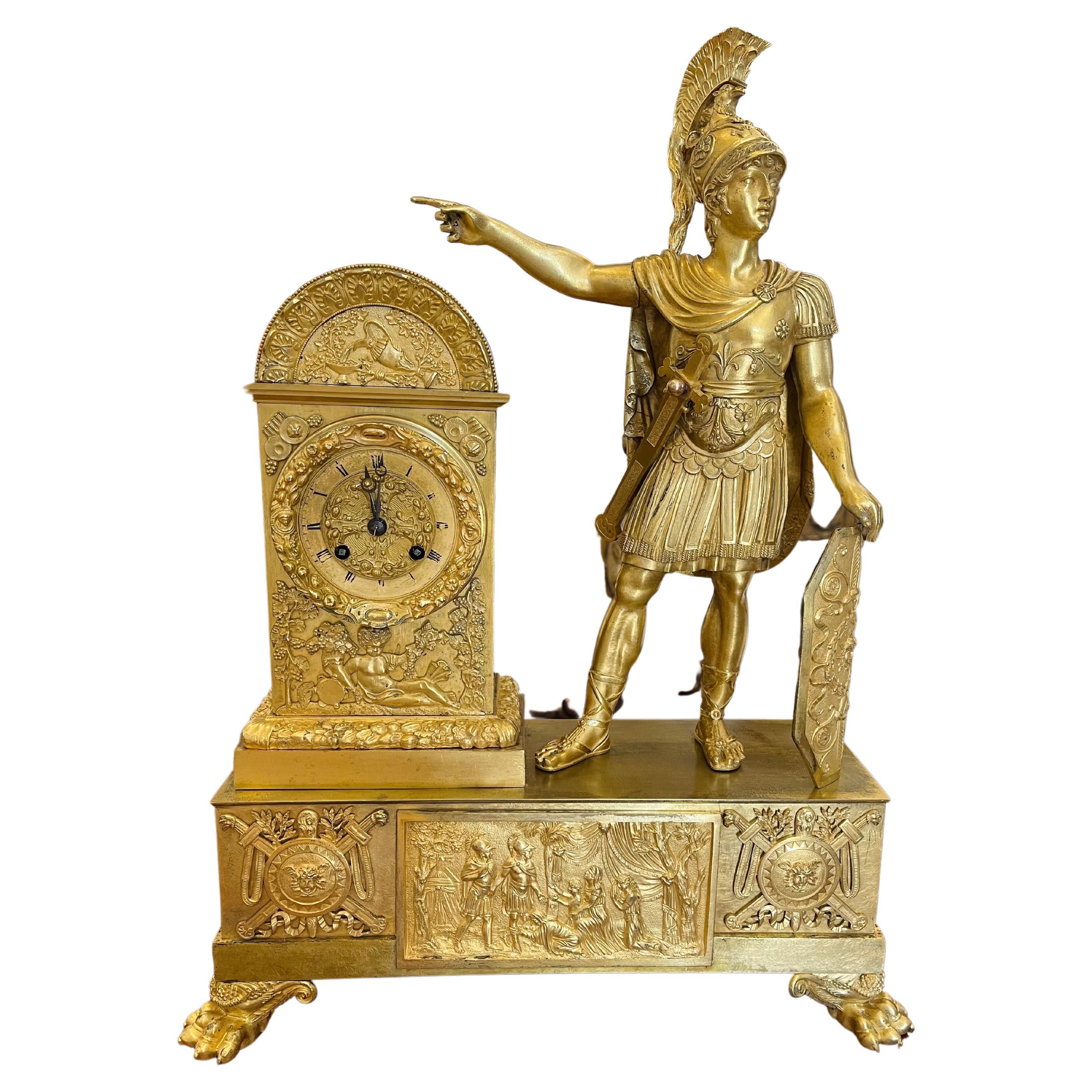 Period French Empire ormolu or gilt bronze clock. Neoclassical motif of Roman Soldier with wonderful and rare cornucopia and lion feet. Plaques of Roman scenes. Robust and dramatic.