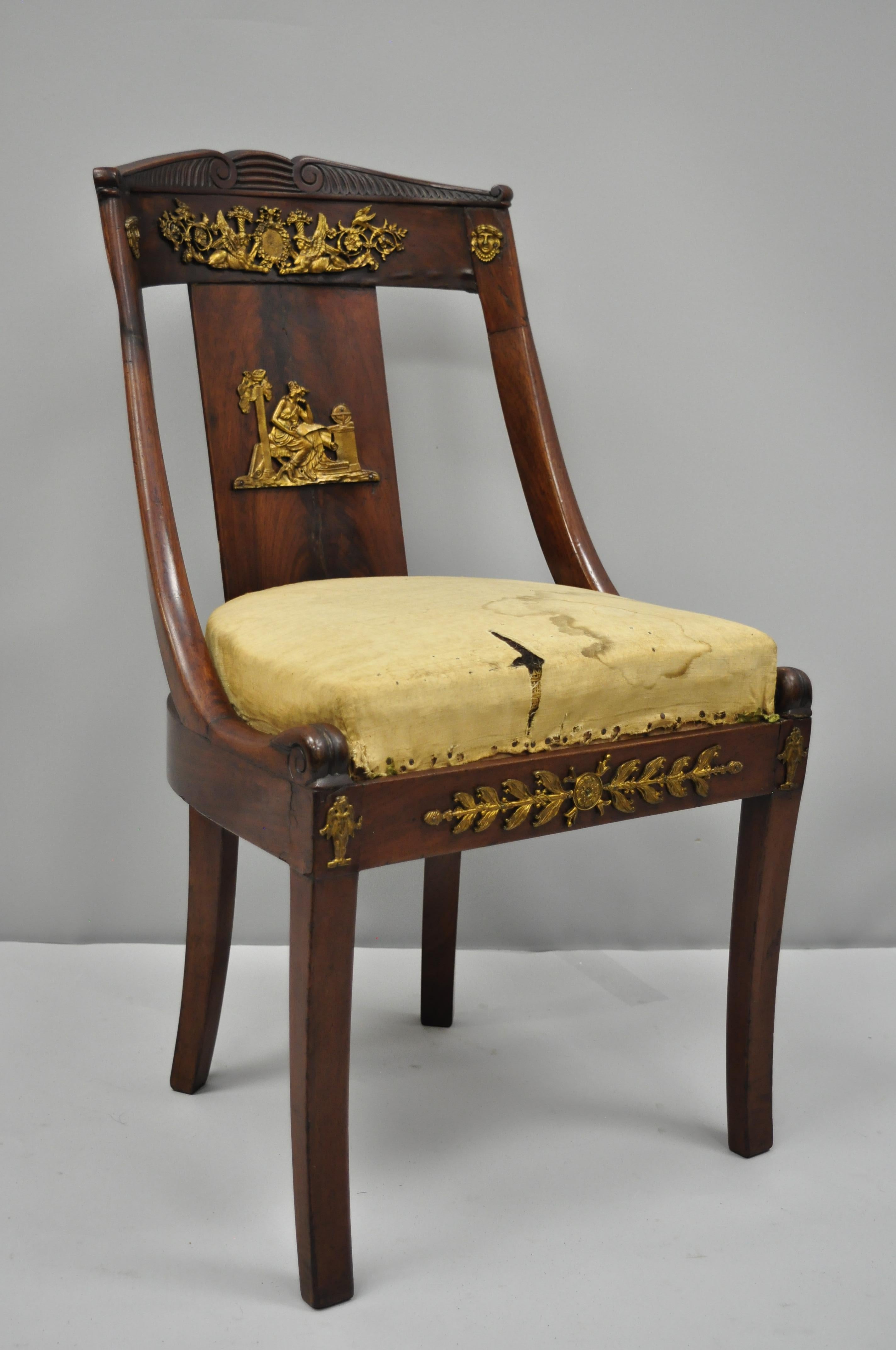 Early 19th century mahogany side chair with bronze ormolu. Item features finely cast bronze ormolu, rounded back with carved top rail, beautiful crotch mahogany veneer, drop seat with horse hair fill, solid mahogany construction, nicely carved