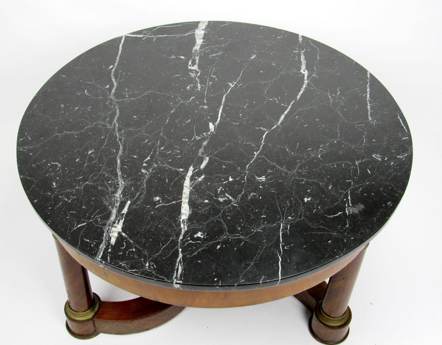 Mid-20th century French Empire style cocktail table with round marble top and swirled base.