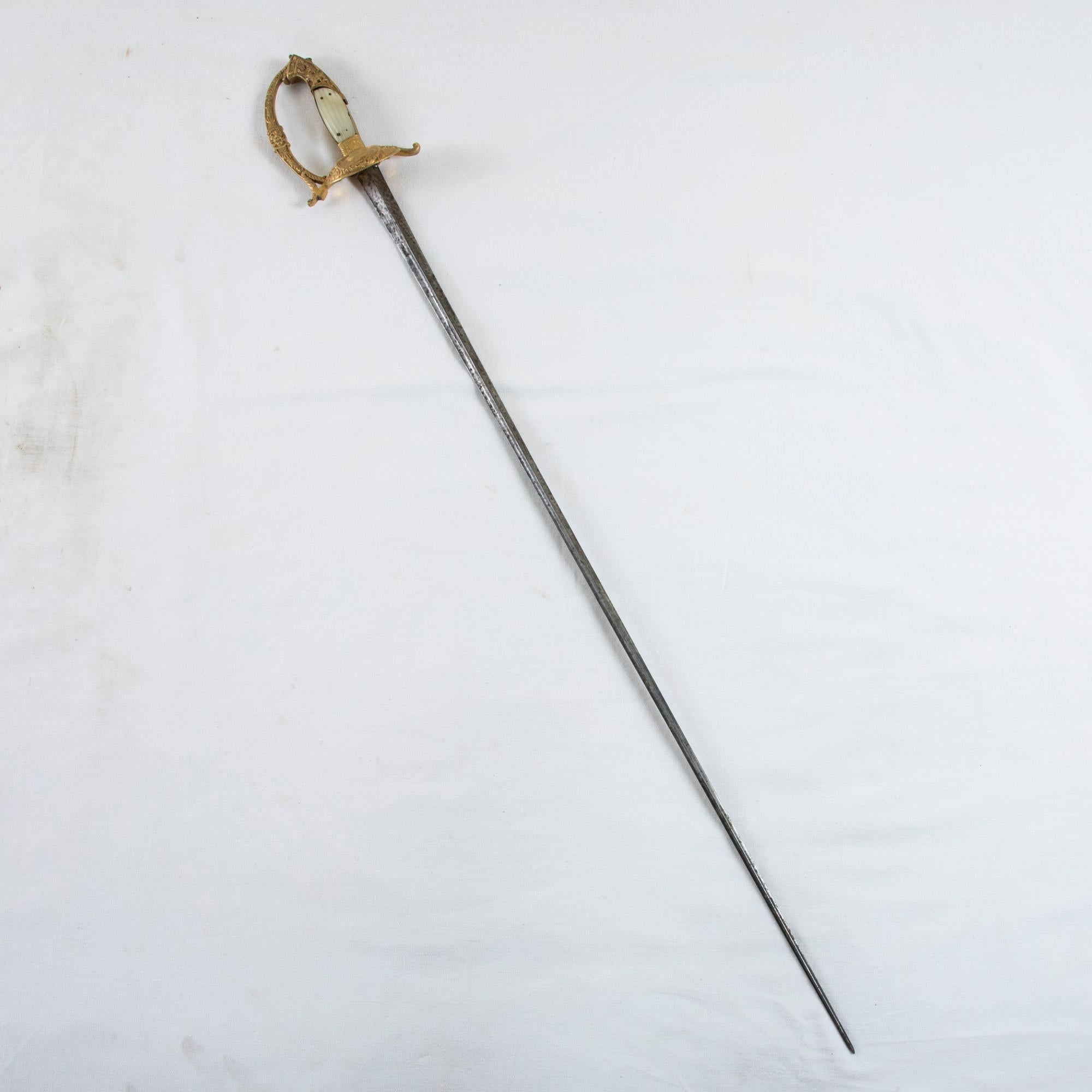 This early nineteenth century ceremonial dress sword features a gilt bronze guard with the profile of Louis XVIII flanked by fleur de lys. Presumably owned by a Frenchman sympathetic to the monarchy after the fall of Napoleon Bonaparte, the hilt