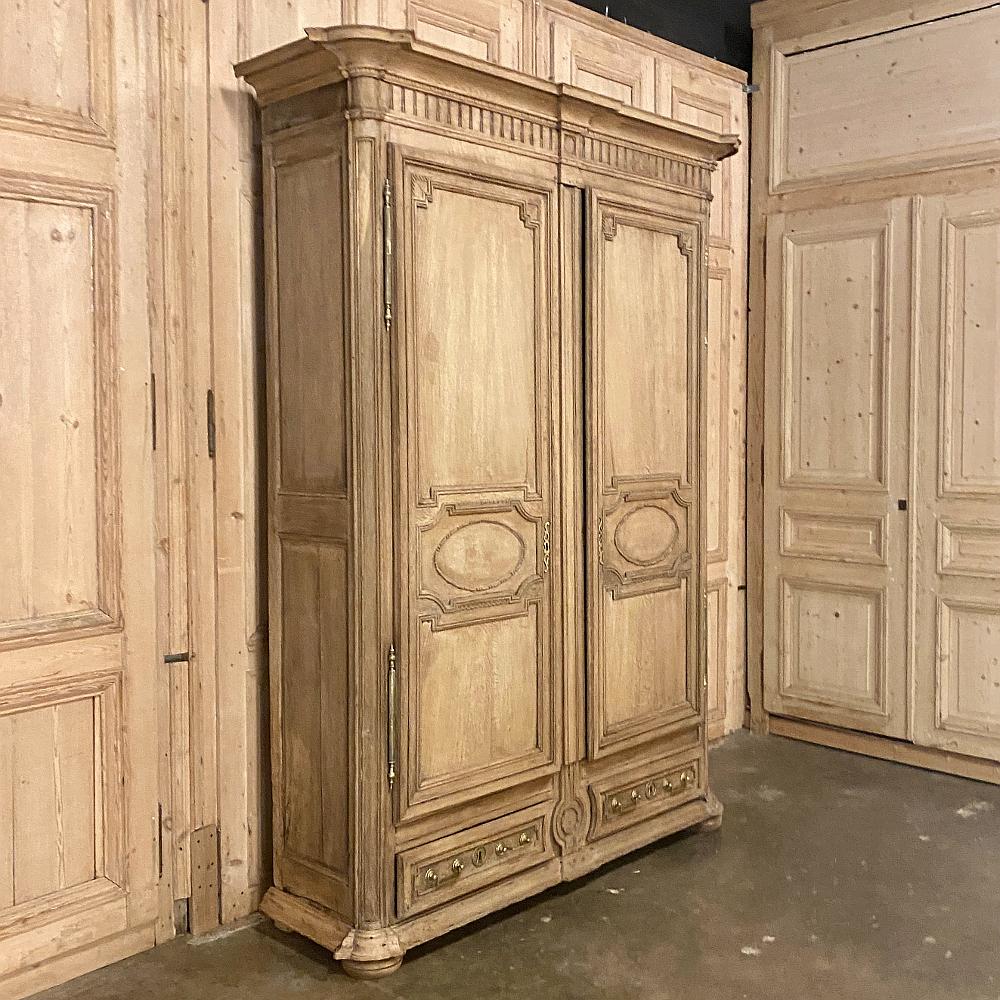 Early 19th century French Louis XIV stripped oak armoire is a masterpiece of the cabinetmaker's art! Using dense, old-growth oak, the artisans started with classical architecture for the design, then lavished the casework with amazing molded detail