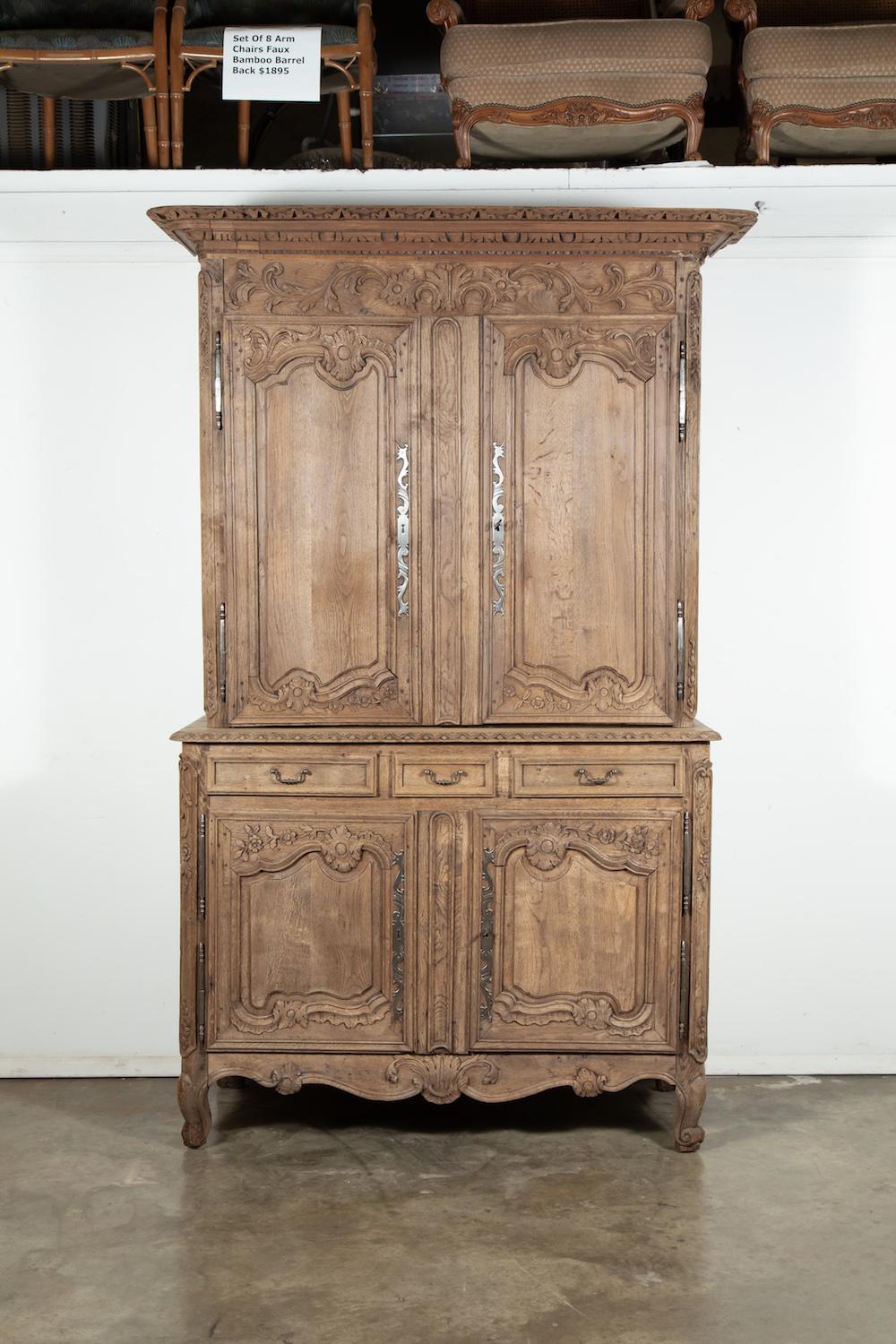 Beautiful 19th century country French Louis XV washed oak buffet deux corps handcrafted by talented artisans of Mont Saint-Michel, an island commune in Normandy. Expertly crafted and sculpted in select French oak, this piece features an upper