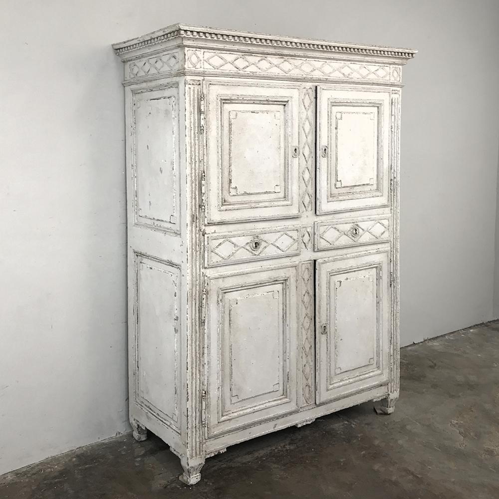Early 19th century French Louis XVI painted cabinet was handcrafted during the waning years of the Directoire style, a fact still evident in the lines. The painted finish has achieved an incredible patina over the almost two centuries since its
