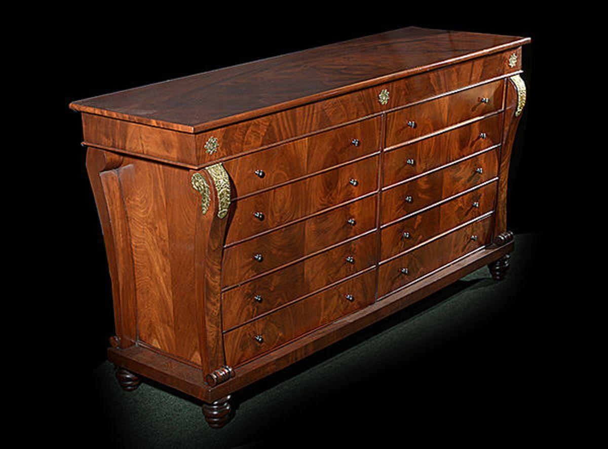 A handsome mahogany early 19th century French chest of drawers ten drawers.
The scrolled supports to each side with decorative brass metal mounts.
The whole raised on turned feet.
 