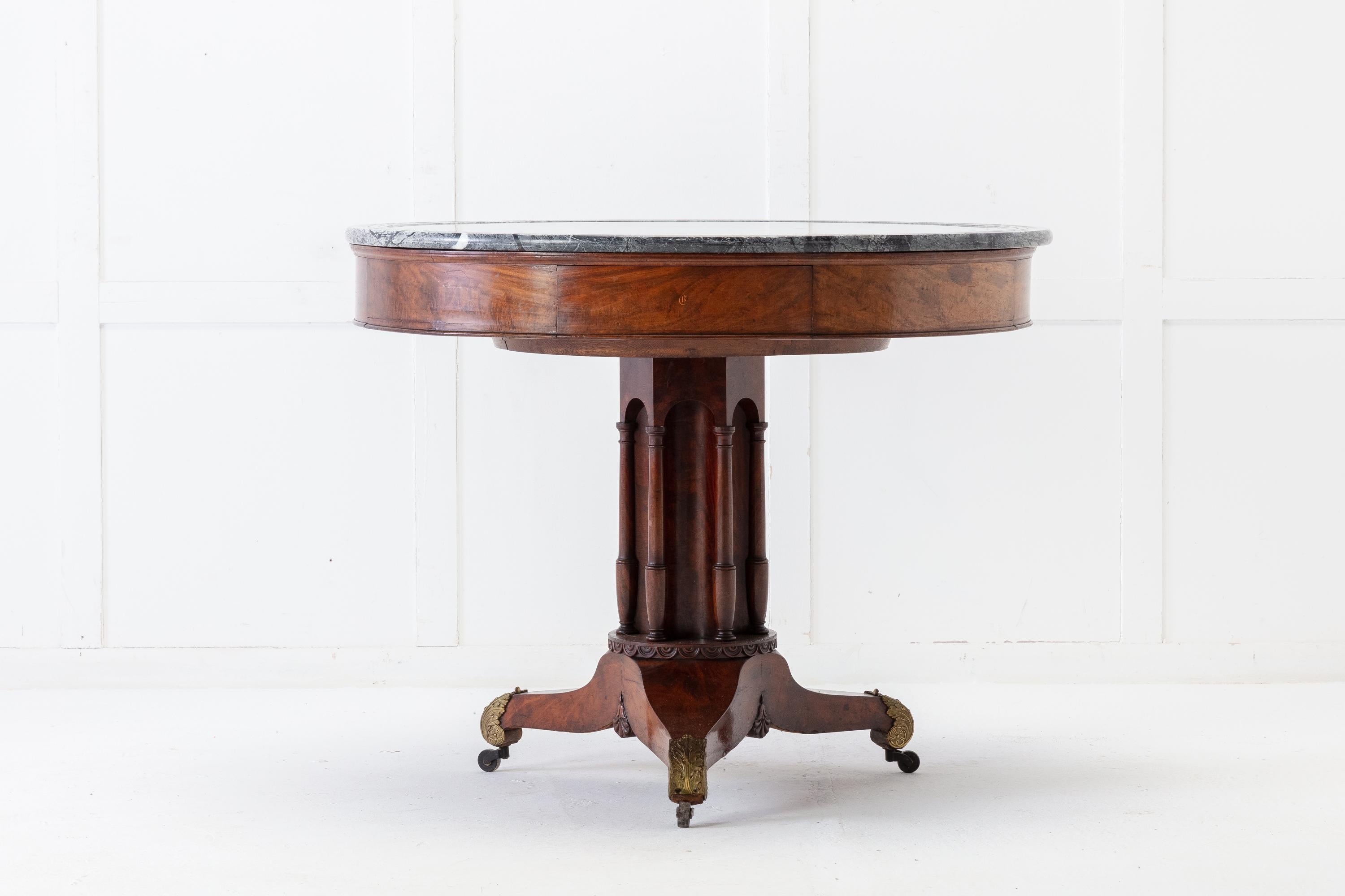 Early 19th century French mahogany table with a super marble top. Having four drawers with exceptional quality mahogany drawer liners. Each drawer having pretty inlaid initials. The top rests on a central stem, with applied pillars, above a