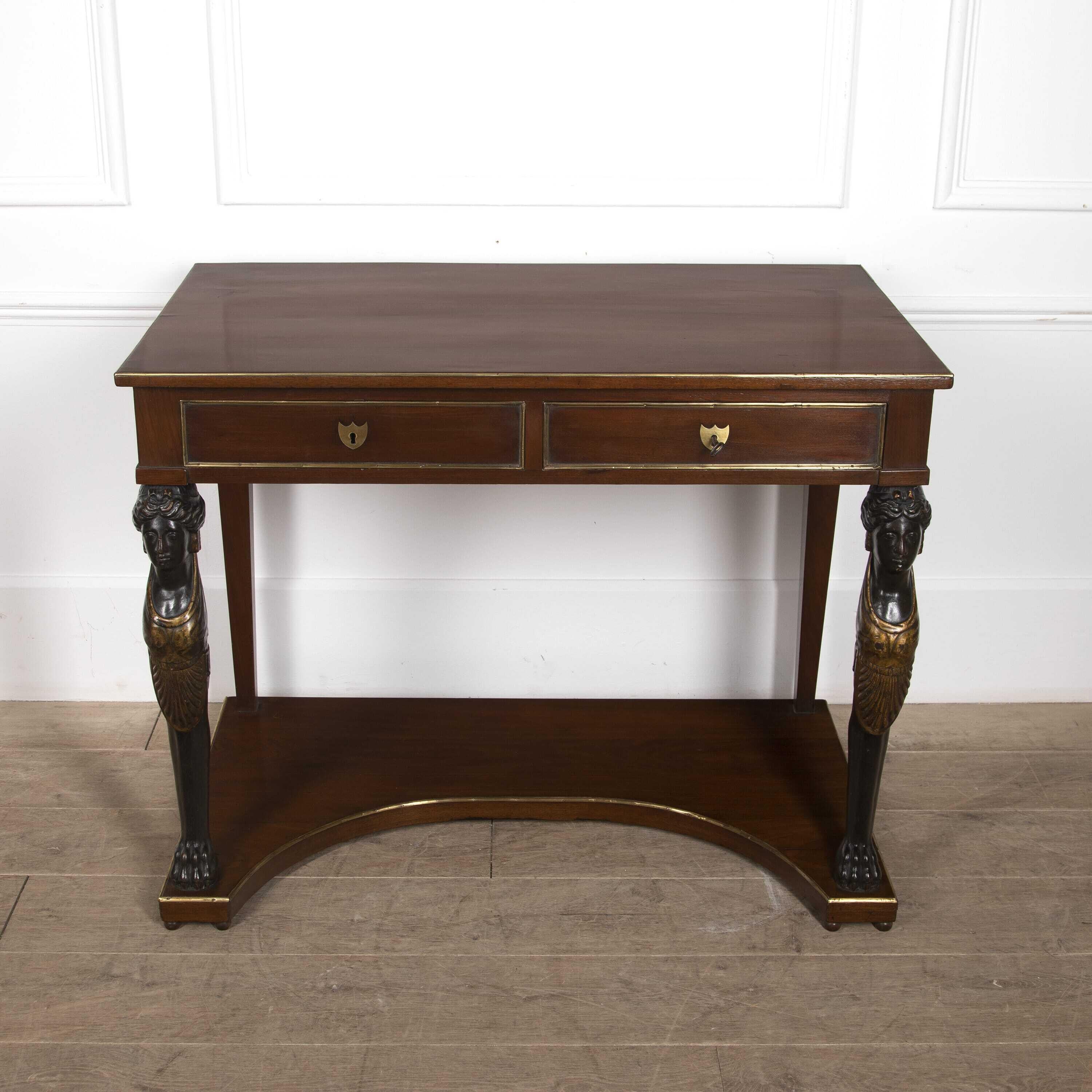 Early 19th century French console table with brass mouldings throughout.
The top has two drawers being supported by finely carved classical female monopodium legs that are ebonised and gilded sitting on carved lion paw feet above a concave base