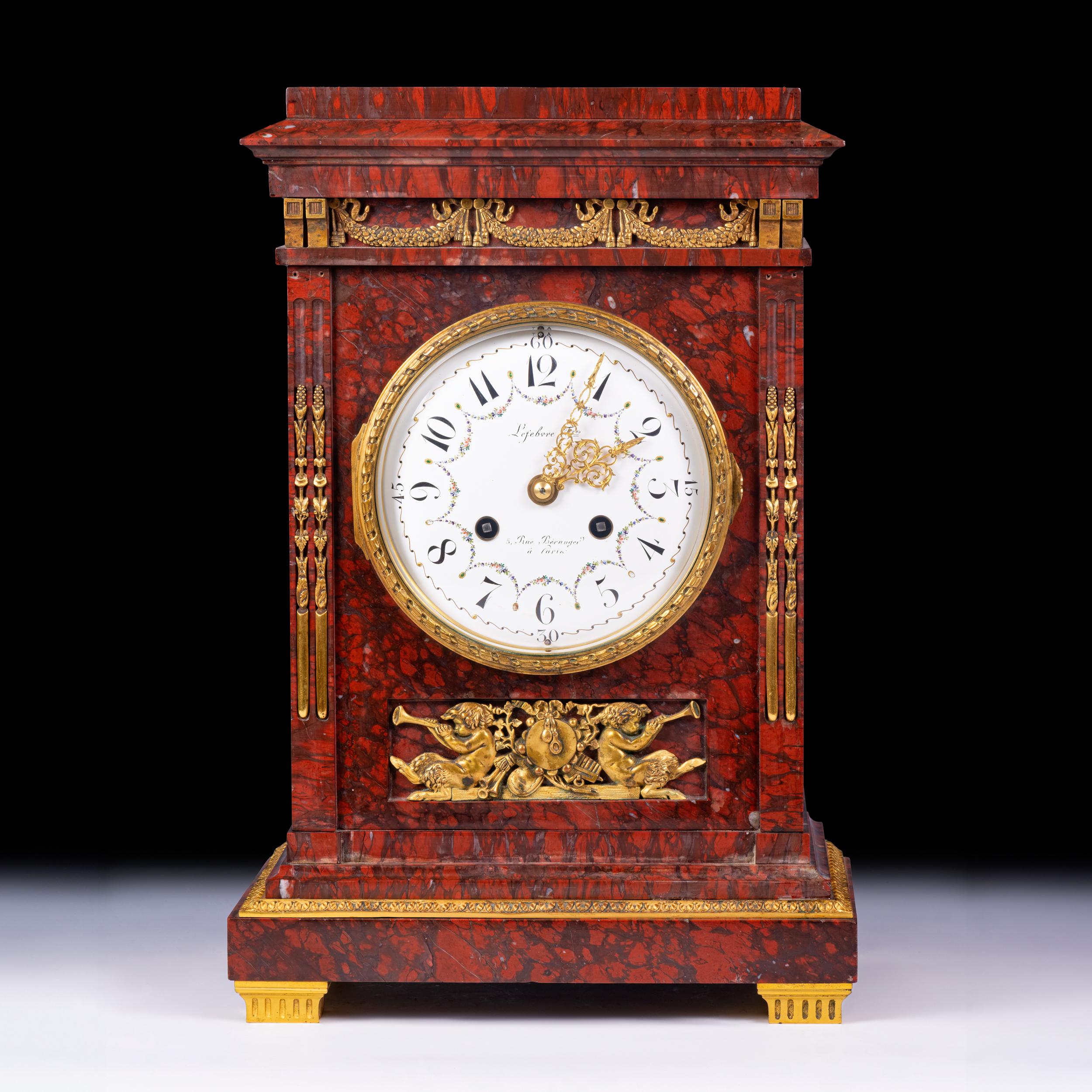 A very fine 19th century Rouge Griotte marble and gilt bronze clock in the Louis XVI style decorated with gilt bronze motifs, of rectangular form the painted floral porcelain white enamel dial with Arabic numerals , circled with a frieze of finely
