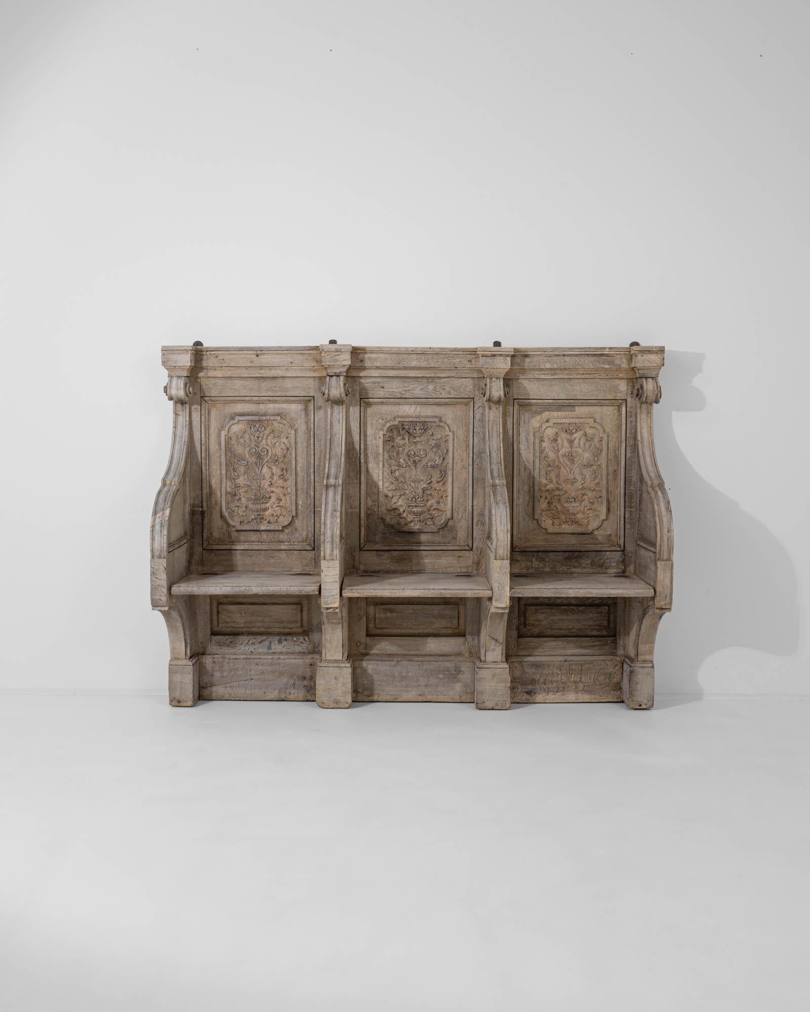 A wooden bench created in early 19th century France. Masterfully sculpted and full of antiquated charm, this fascinating bench exudes an air of poise and rustic farmhouse allure. The segmented shape, richly ornamented, gives this intriguing find a
