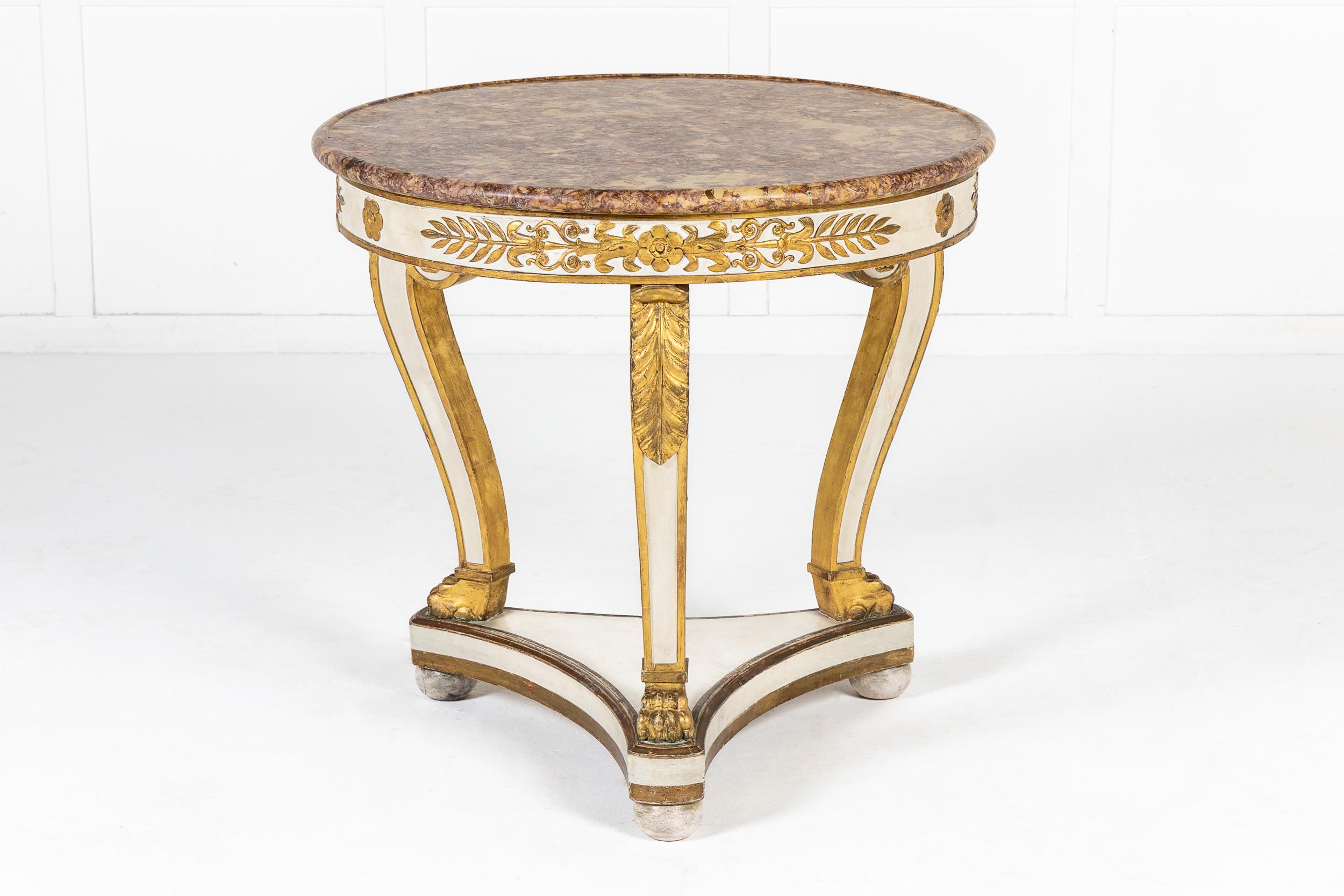 An Early 19th Century French White Painted and Gilt Guéridon, with Fine and Original Marble Top.

The fine marble top supported on a white painted frieze with parcel gilt decorative details of typical Empire type and very fine quality. These details