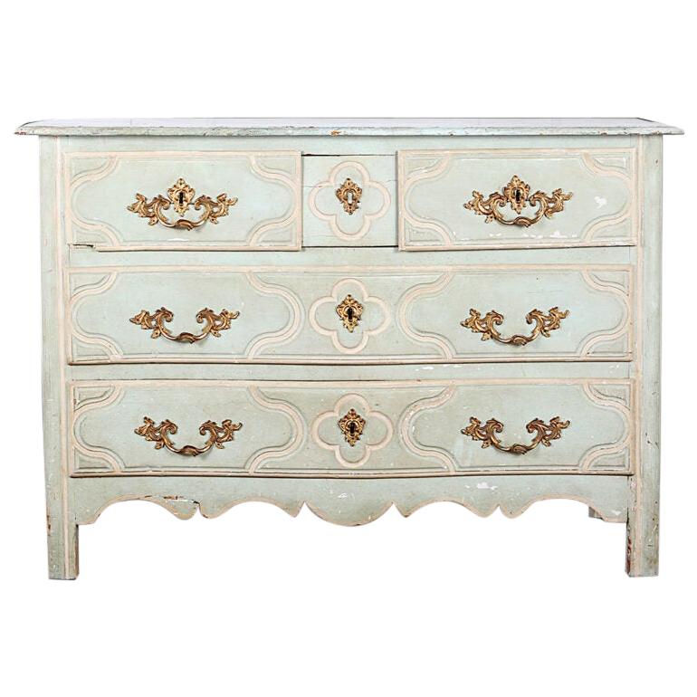 Early 18th century French painted Regence  serpentine  commode with two short over two long drawers with shaped molded drawer details and original ornate ormolu pulls. Carved scalloped front apron and shaped panelled sides, circa 1780.


 