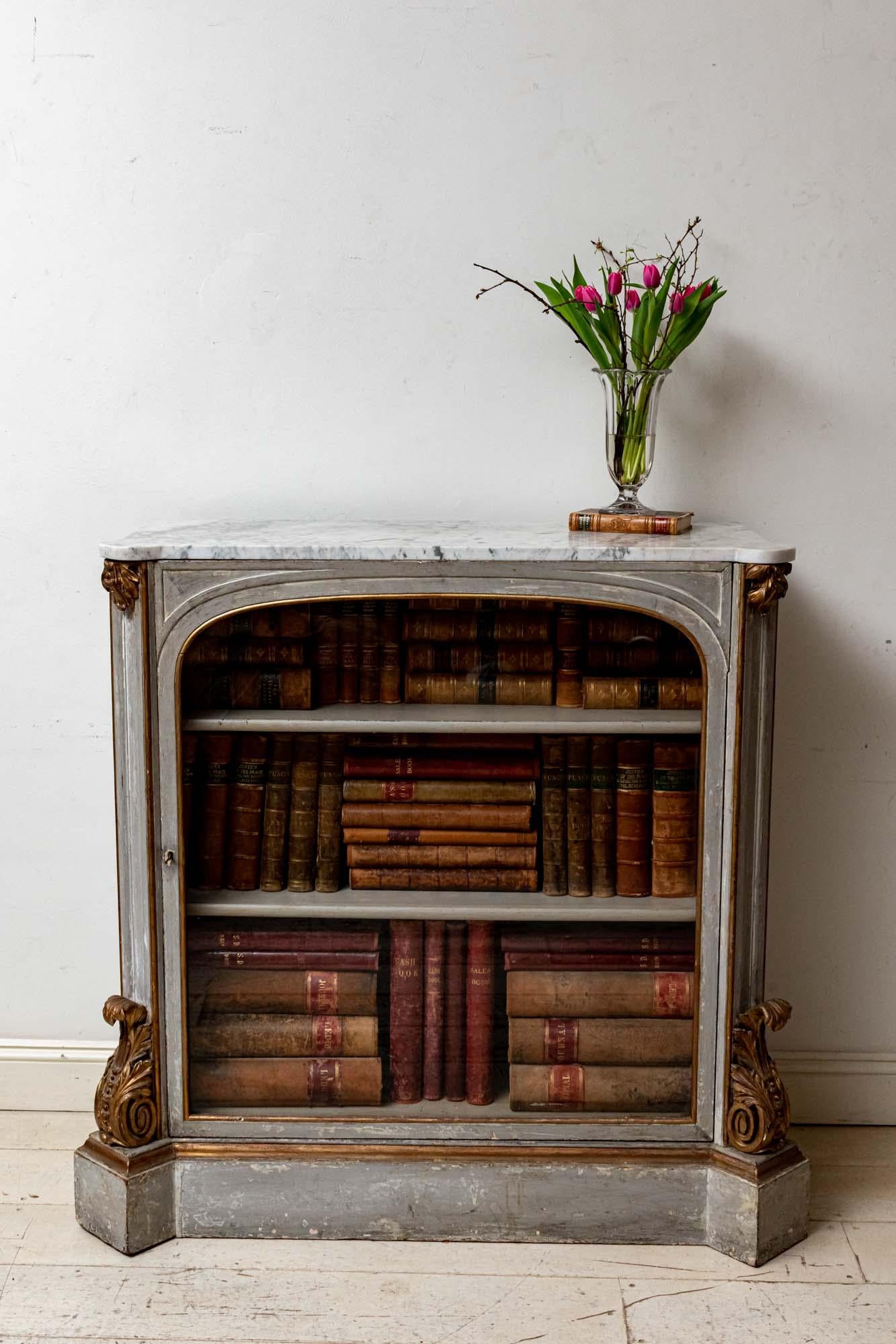Wonderful early 19th century hand painted glazed cabinet or bookcase, with a lovely original shaped Carrara marble top. 
Gilt decoration to the side.
Marble is in excellent condition.
Paint work and gilding is good.
The back has been extended