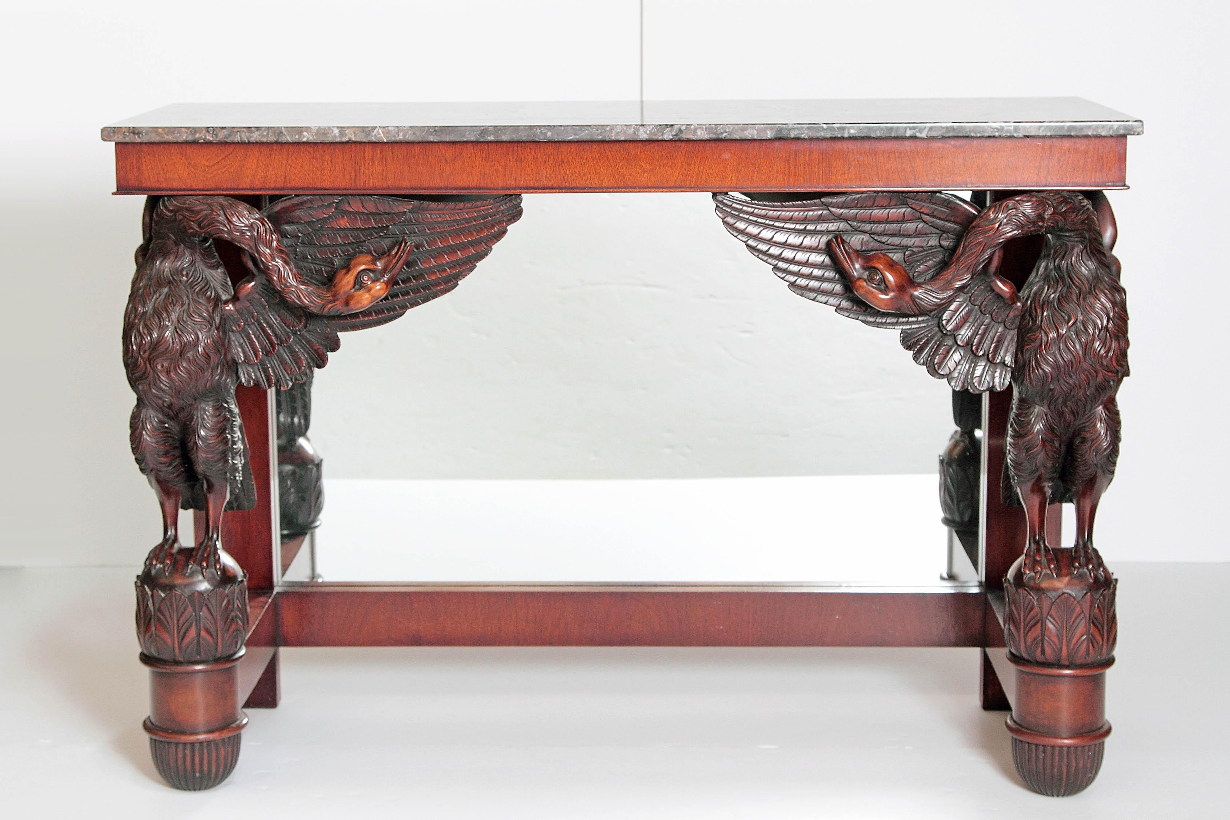 A mahogany pier table with carved swans, mirrored back and grey marble top (not original to the piece) early 19th century France (marble top replaced).