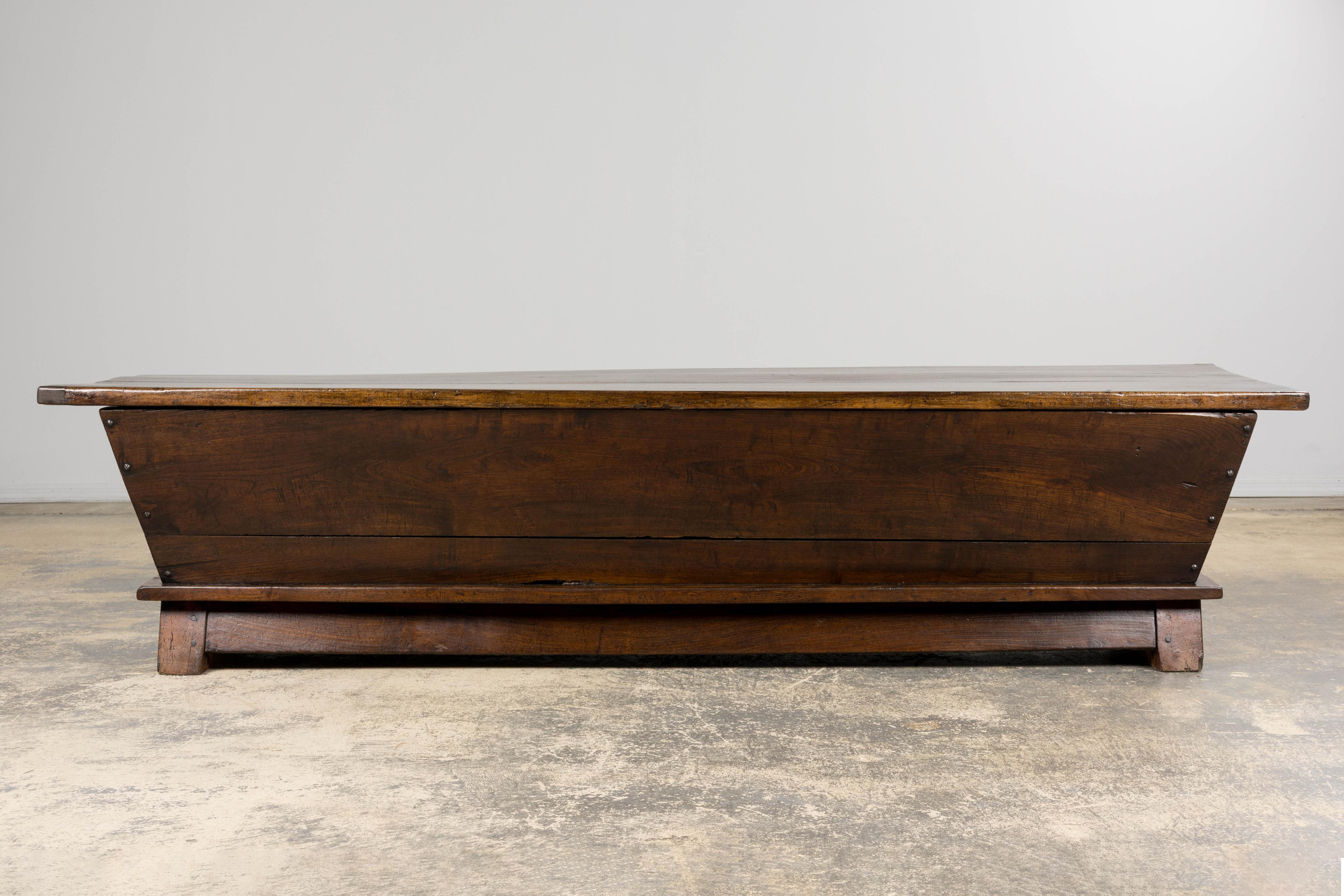 A rare early 19th century French Provincial dough bin table from Provence, beautifully combining historic authenticity with modern versatility. Originally crafted in solid walnut, the piece was designed with a sliding two-plank top that opens to