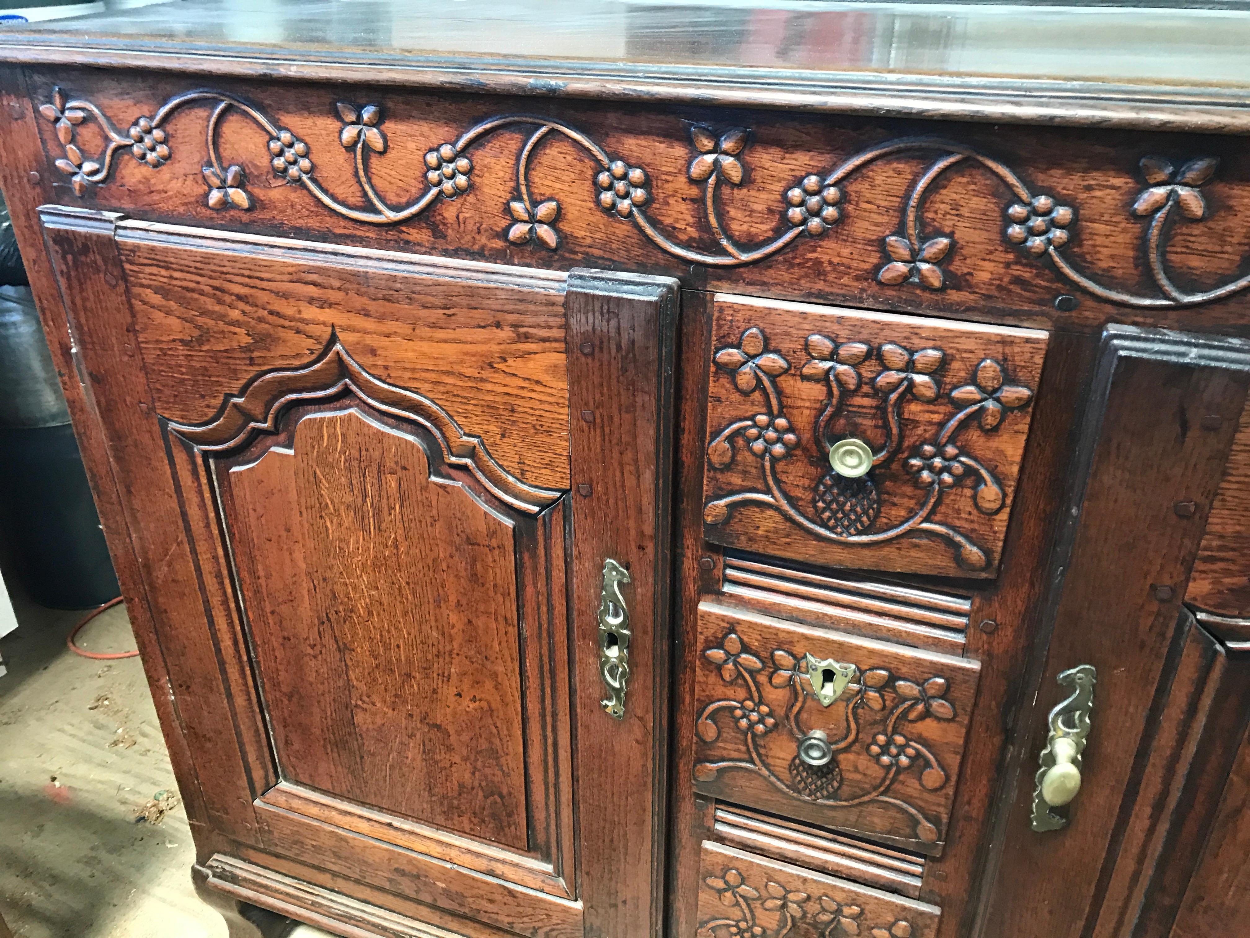 Wonderful craftsmanship made of chestnut with a deep patination and rich lustrous color and unusual narrow proportions. Gothic style arched doors with remarkable carved decoration typical of the region depicting vines, flowers, and grapes retaining