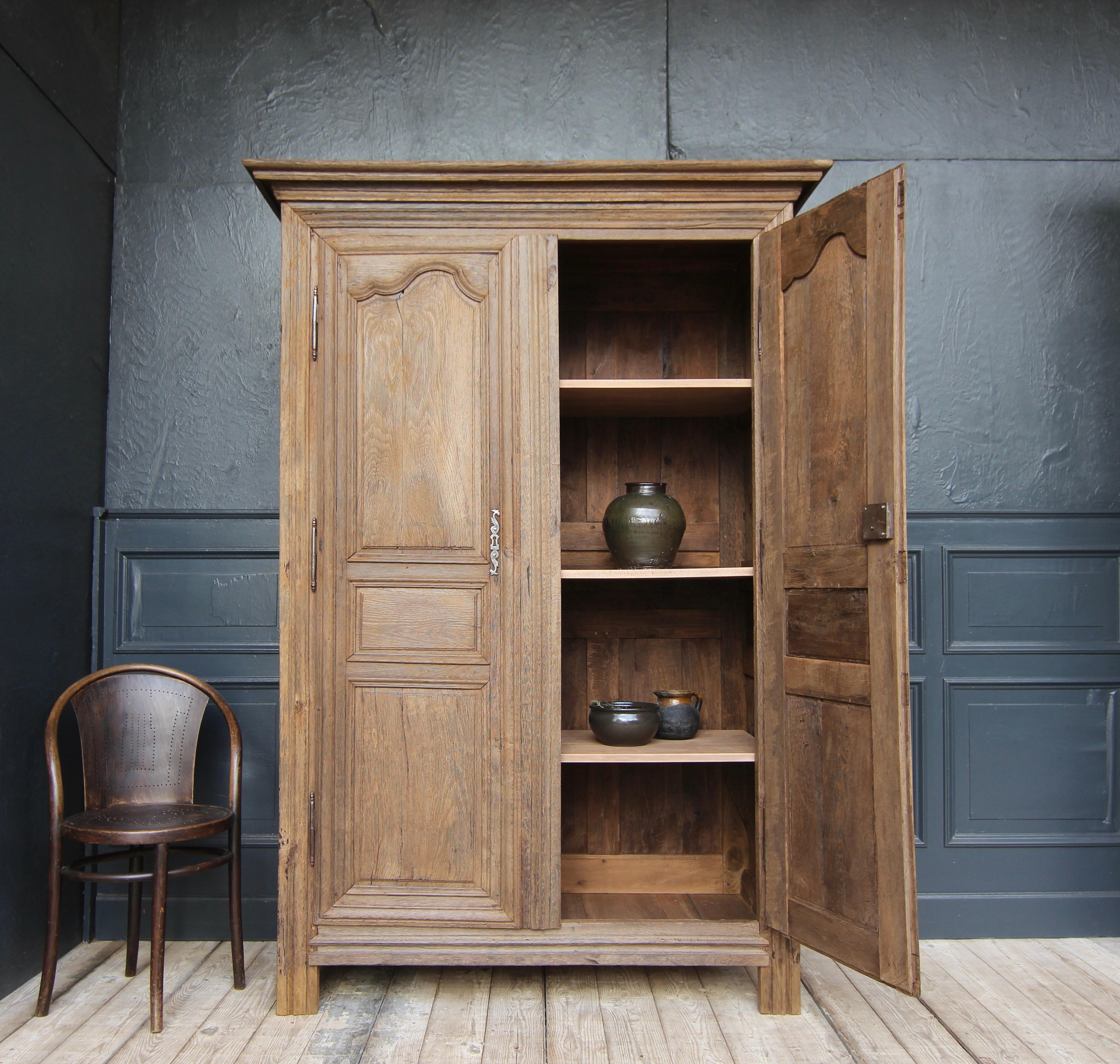 A early 19th century french provincial cabinet or wedding cabinet made of solid oak. 

An authentic piece of furniture whose particular appeal lies in the combination of clear classic design and the charming texture of the old oak wood surface.

