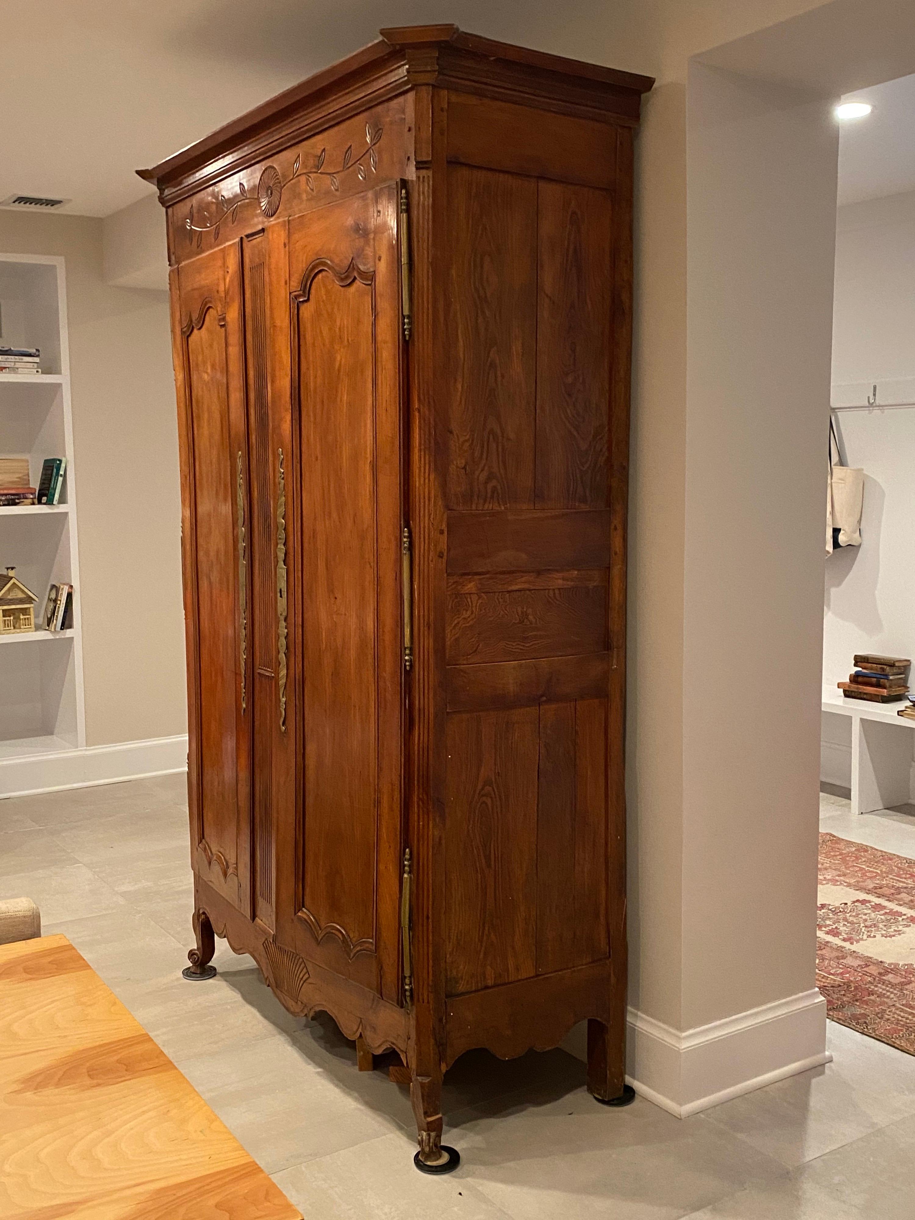 Early 19th century French Provincial walnut armoire.
This is a stunning armoire which needs some restoration. It is priced accordingly, the legs were broken when moved. It is presently propped up but the legs are not attached. Lovely simple