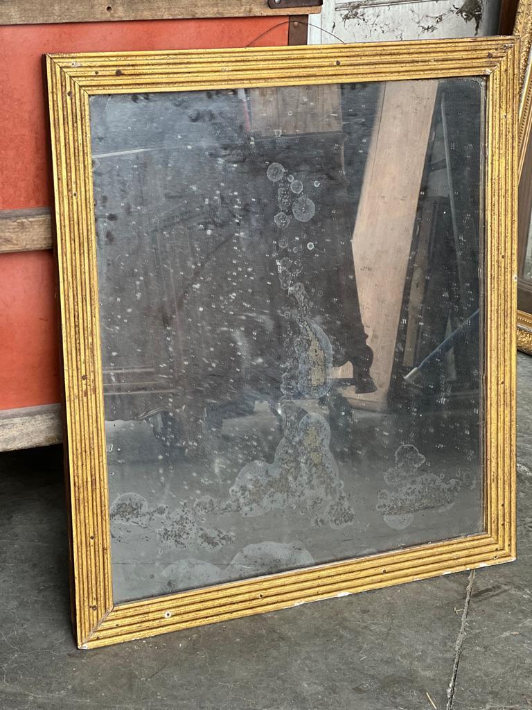 A lovely French Reeded frame gilt wall mirror. Dating to the early 19th Century and having its original plate and back. The plate is spotted and the mercury is worn but if you are looking for a characterful mirror then its just how you would like