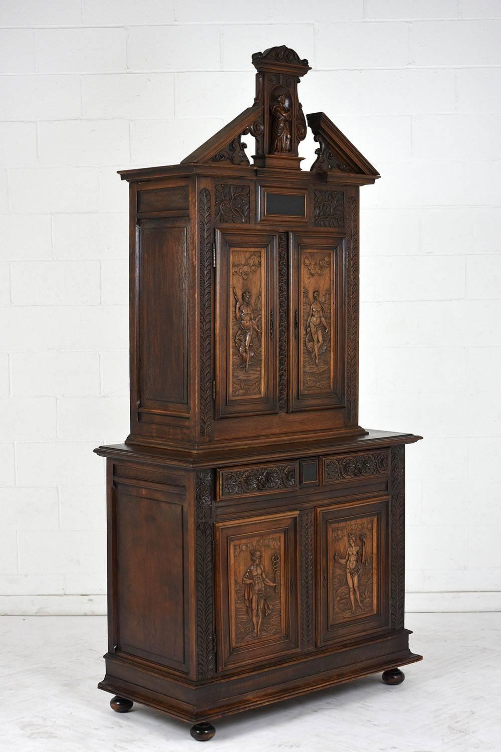 This 1820s French Renaissance style sideboard is made of walnut wood stained a rich walnut color with a polished finish. The ornately carved sideboard is adorned with floral, leave, and figurative carvings of mythical gods and goddesses. At the top