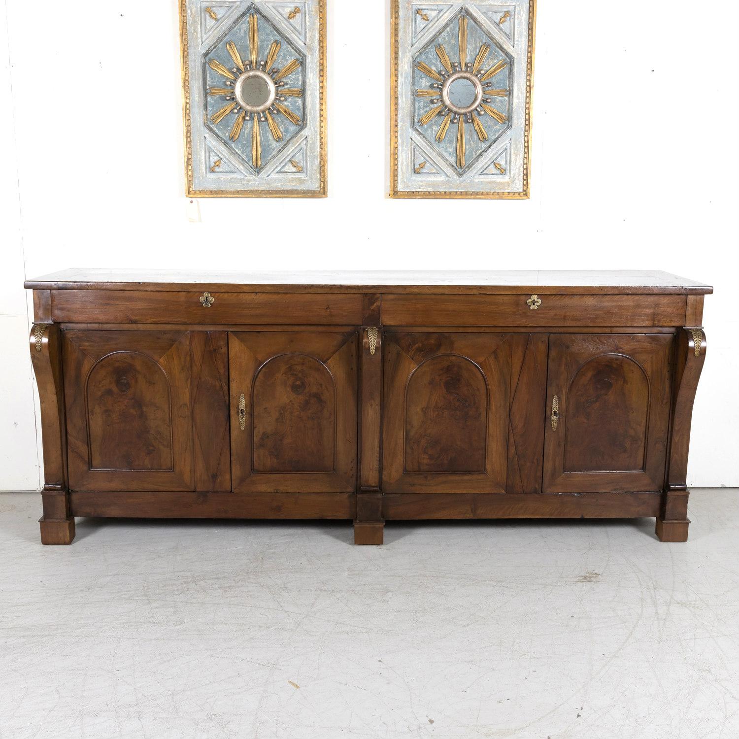 A rare, early 19th century French Restauration period chateau enfilade, circa 1815-1830, handcrafted of solid walnut by master artisans for a castle in the Loire Valley, where most of the French royalty preferred to spend the bulk of their time. A