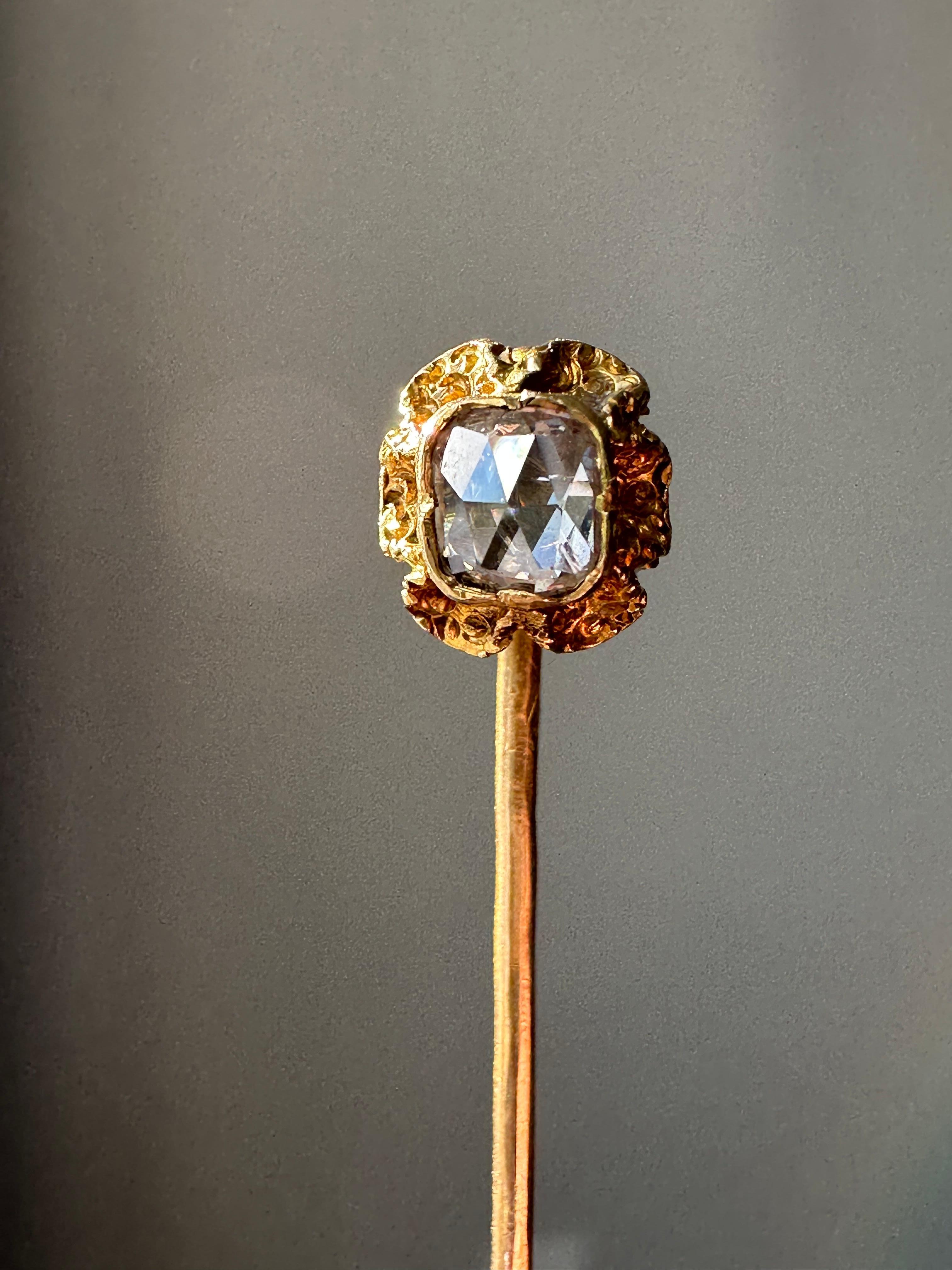 This early 19th century stick pin features all the making of an antique piece of French art: solid 18k gold, high quality engraving, and brilliant craftsmanship. Of course the main feature of the stick pin is the elongated rose cut diamond placed