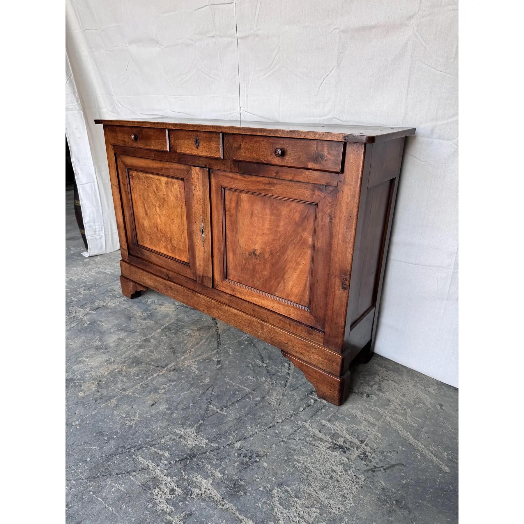 Notice the shallow depth of 15 inches, this is a very unique French server from the early 19th century in walnut which gives it such a nice warm brown tone. A clean and simple design with two drawers over two doors that both open to ample amount of