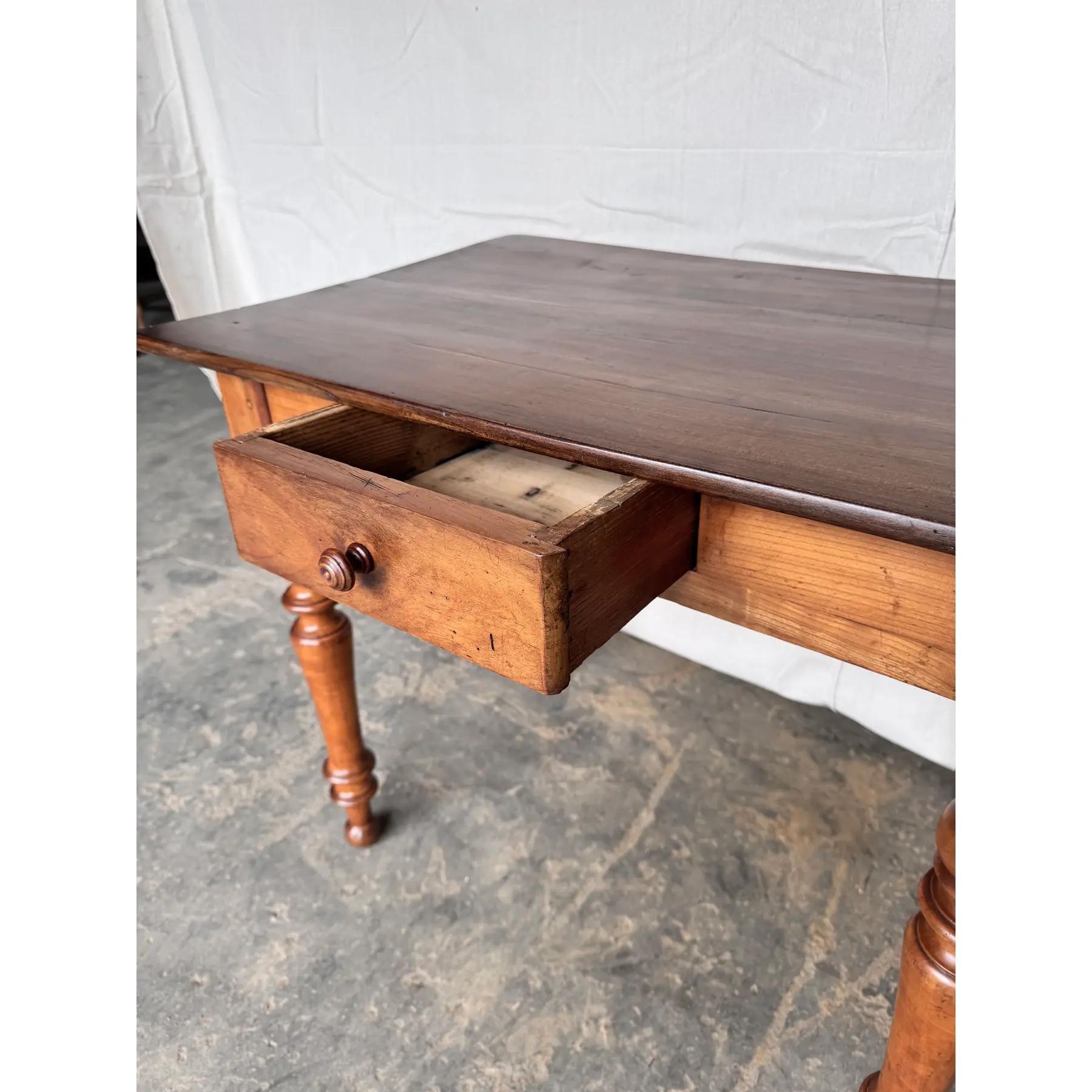 19th Century French cherry side table table from the south of France. With a beveled edge around the top this follows down to a simple apron which contains a single drawer in the front and simple sides. The piece is raised on hand turned legs. The