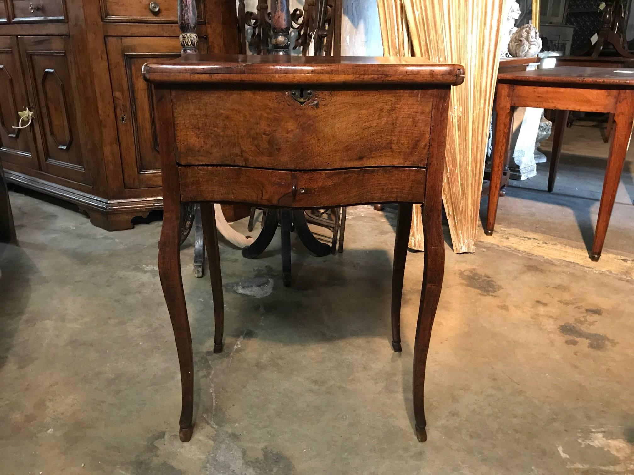 An outstanding early 19th century, French side table beautifully constructed from walnut. Tremendous patina, rich and luminous. The Perruquier table was used for storing wigs.