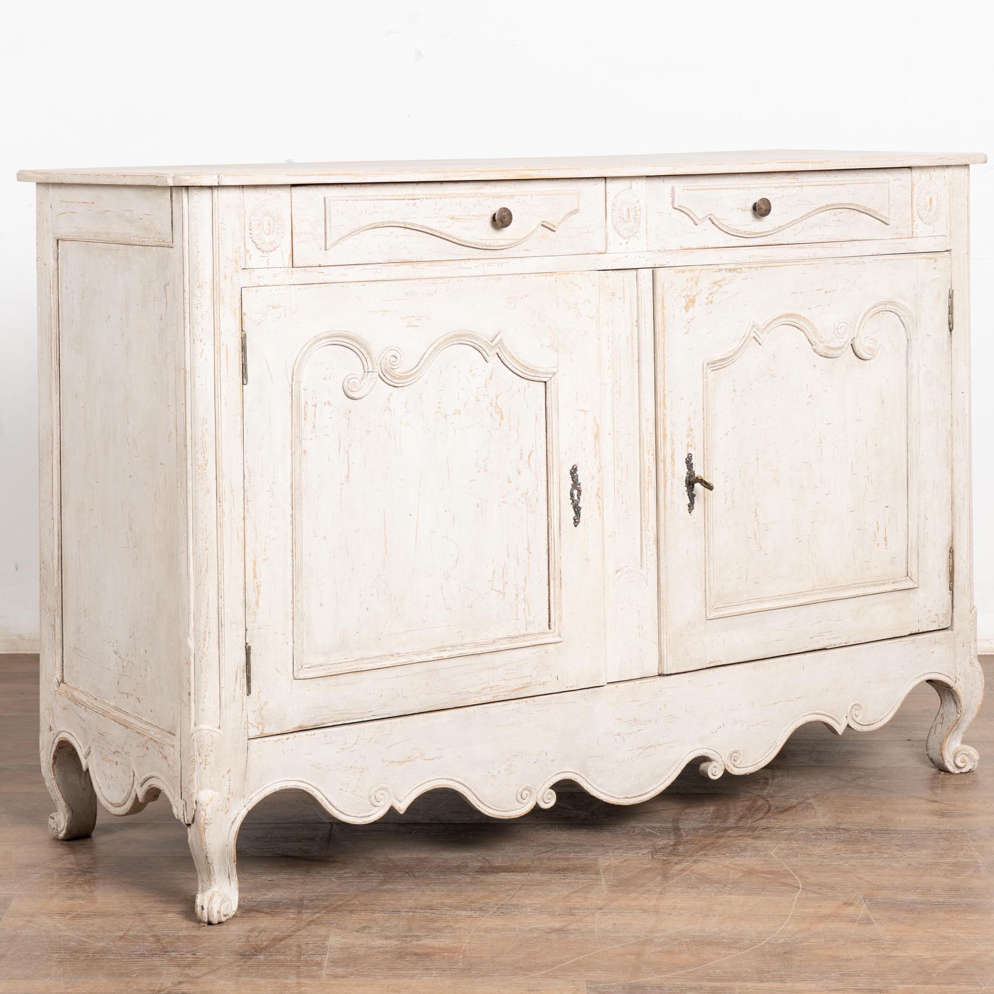 Dieses hübsche Sideboard wurde weiß lackiert und verleiht dem charmanten französischen Landhausstil einen frischen Touch.
Die Farbe wurde sanft abgenutzt, so dass das natürliche Holz darunter zum Vorschein kommt und das Finish eine gealterte