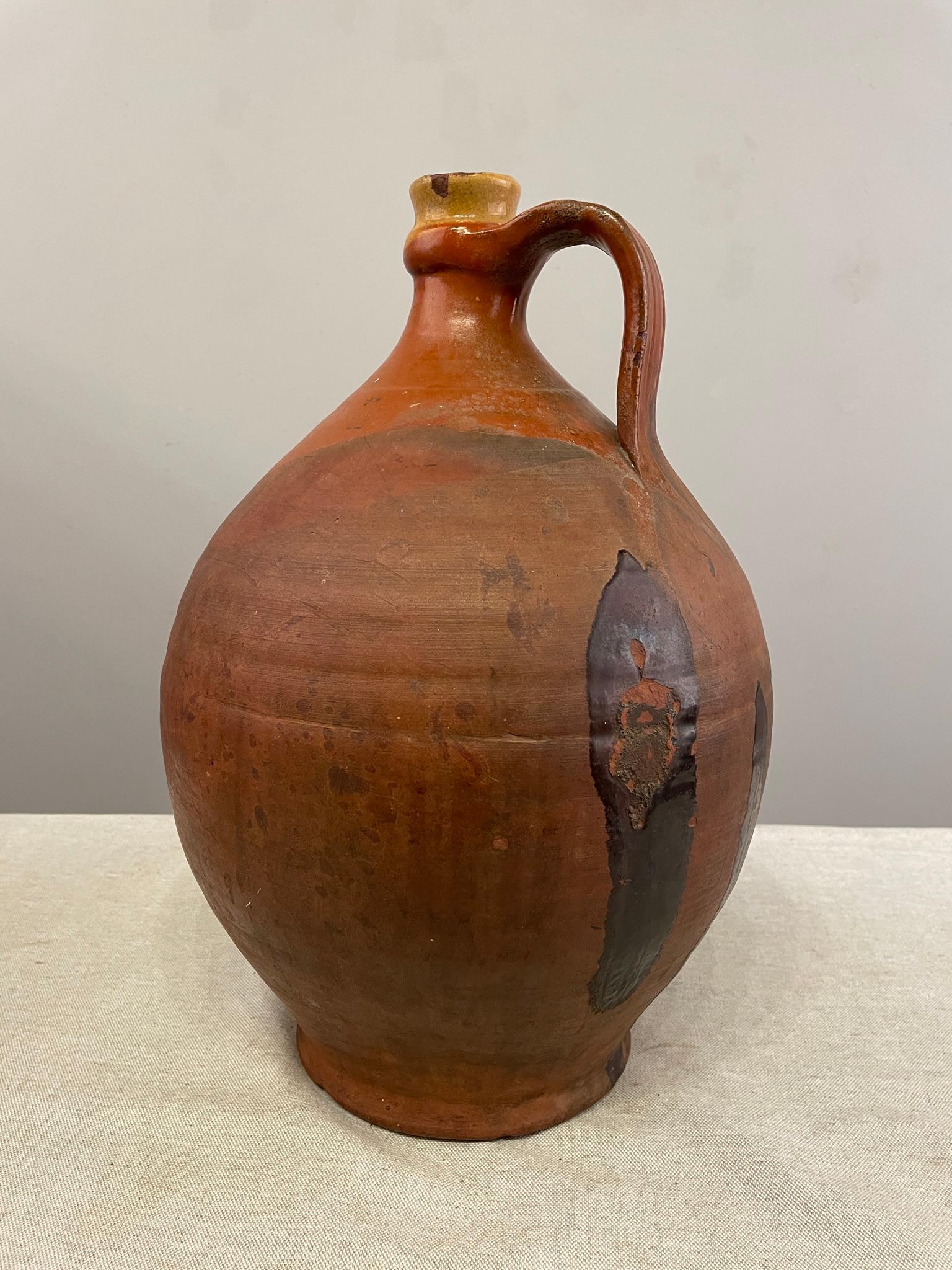 A French Terracotta Pottery water jug with some glazing near the top. Great color and it weighs 9 Lbs. Dimensions are 15