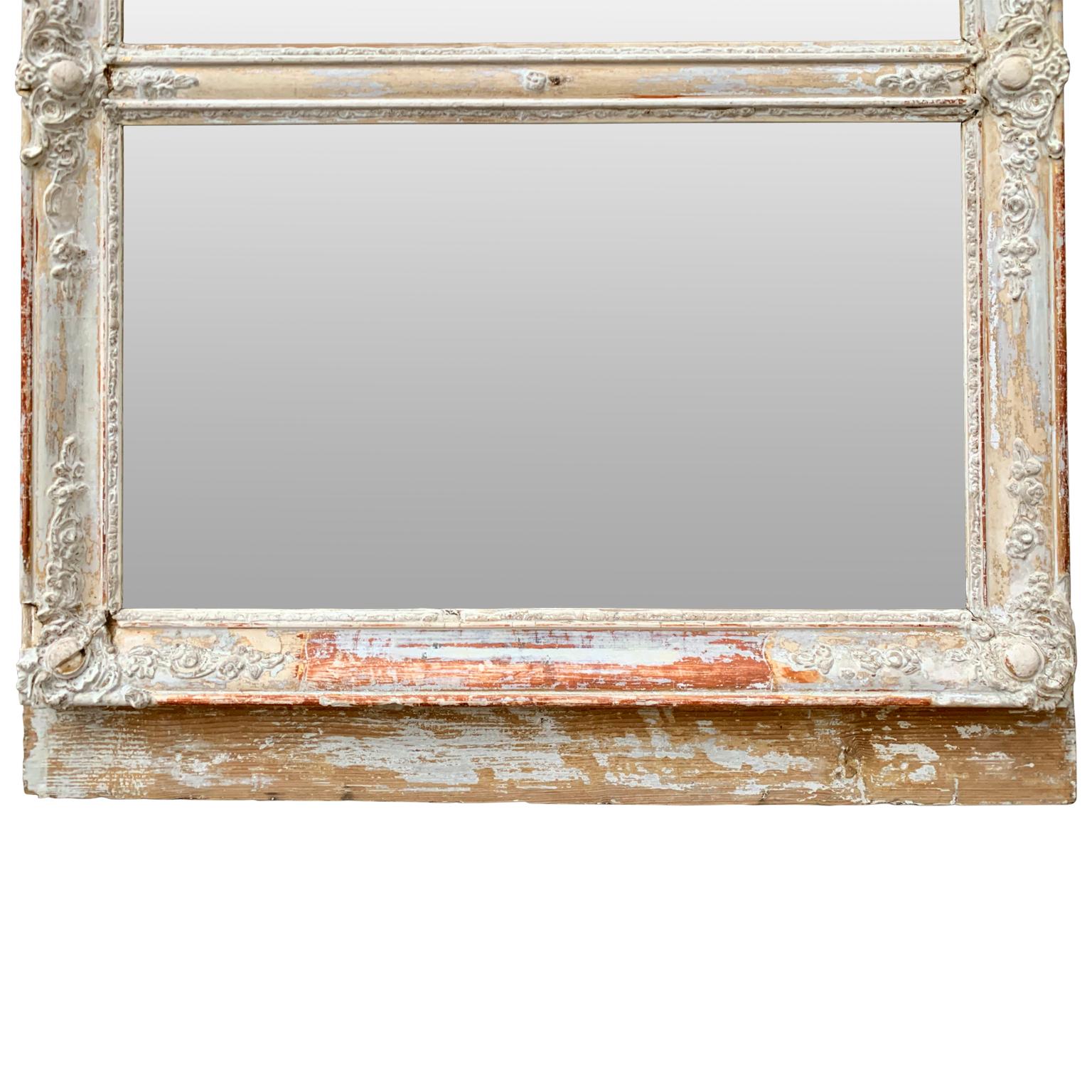 An early 19th century French Trumeau mirror in its original frame and mirror glass.
 